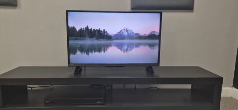 Toshiba 32LF2F53DB and Sony Blu-ray player on TV unit with mountain displayed on screen