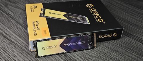 An Orico O7000 SSD on a table with its retail packaging