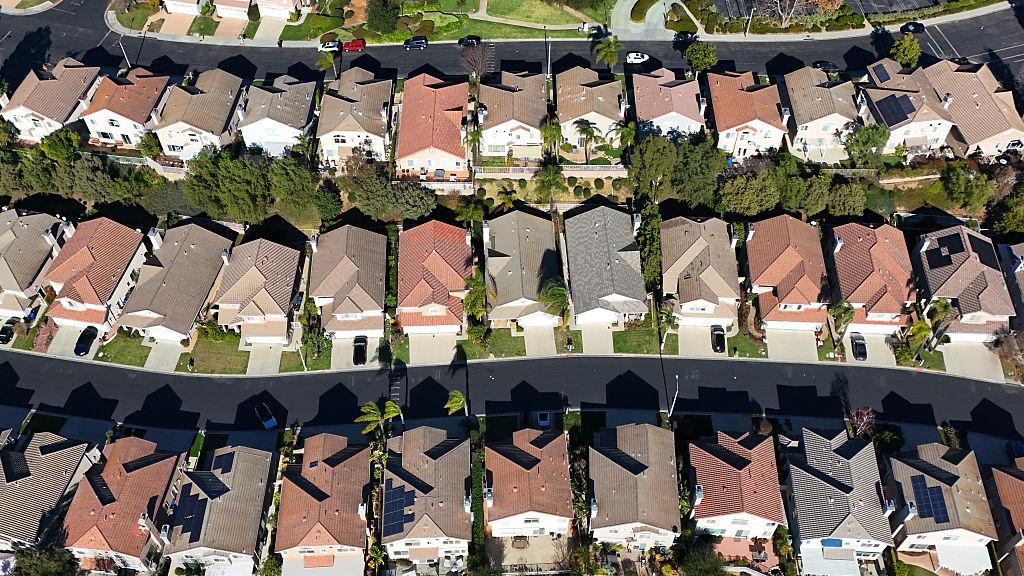 In an aerial view, two-story single-family homes line the streets