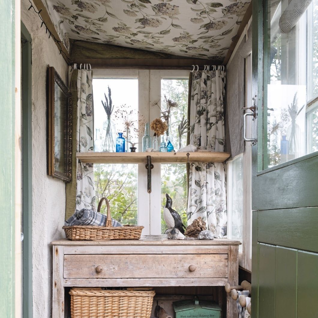 Small rustic lean-to porch with fabric tented ceiling and matching curtains