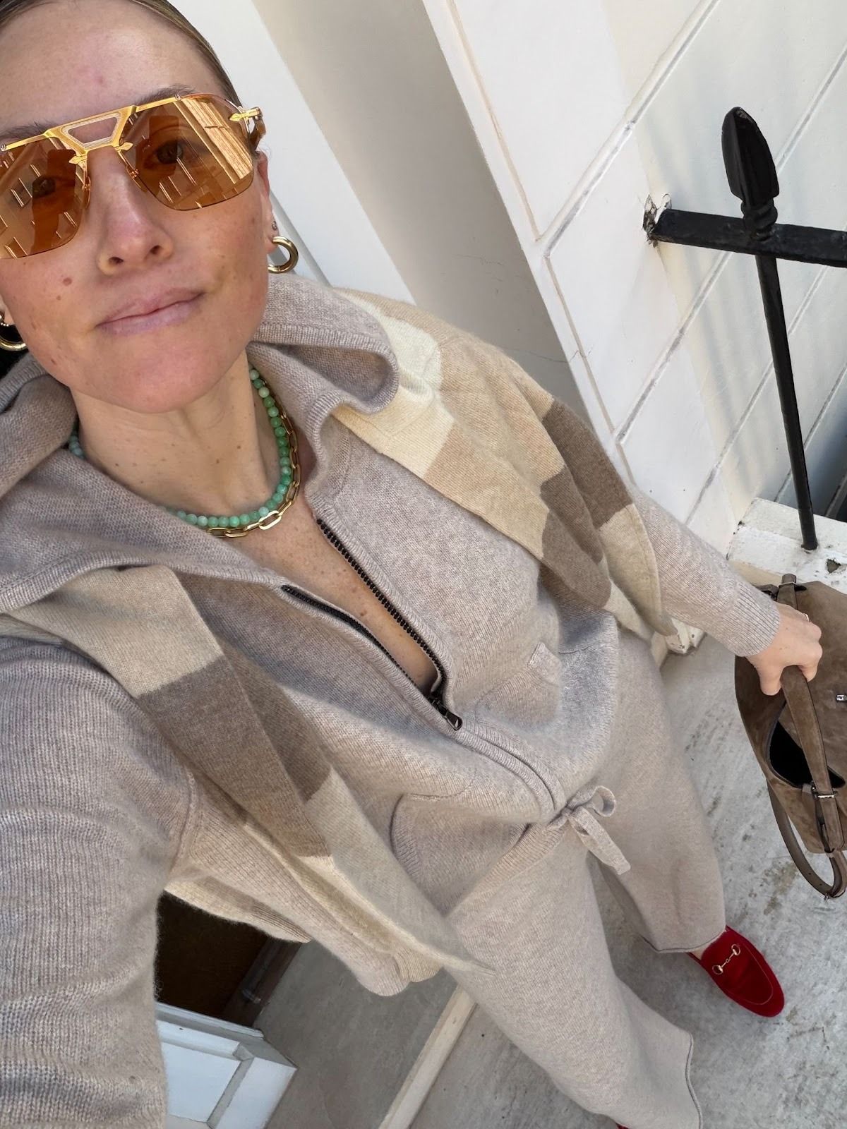 Brooke Ely Danielson wearing a gray sweatsuit and red loafers