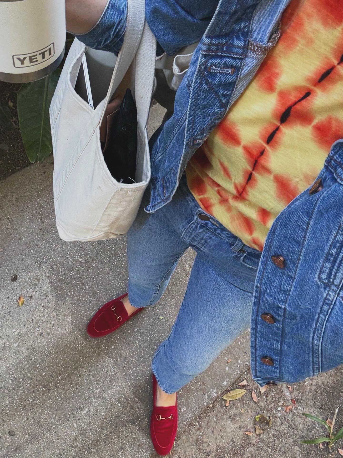 Brooke Ely Danielson wearing jeans, a denim jacket, red loafers, and her boat and tote
