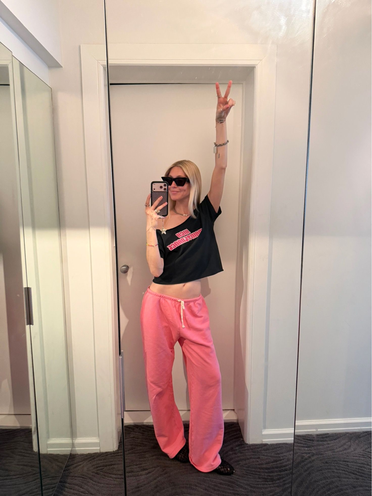 Jessica Minkoff styles bright pink athleisure with ballet flats