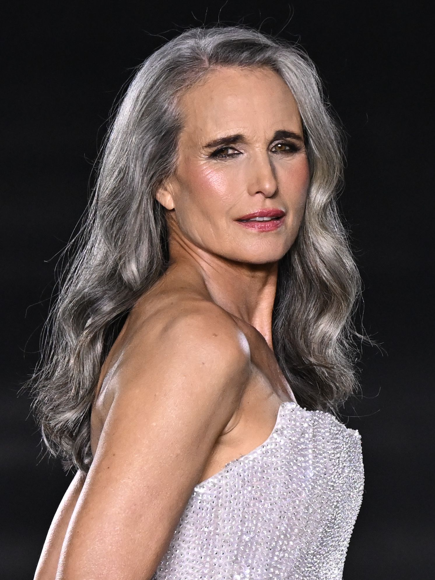 Andie Macdowell wearing lived-in grey hair