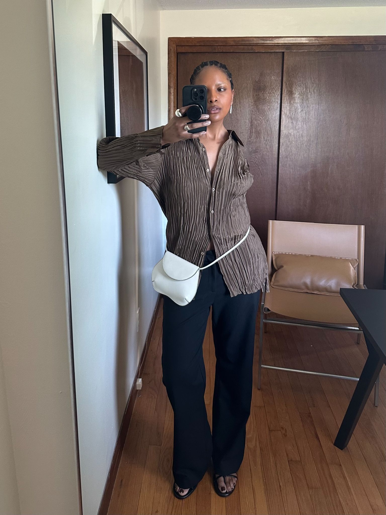 Maya Moore wearing. atop and a black trousers and a white bag