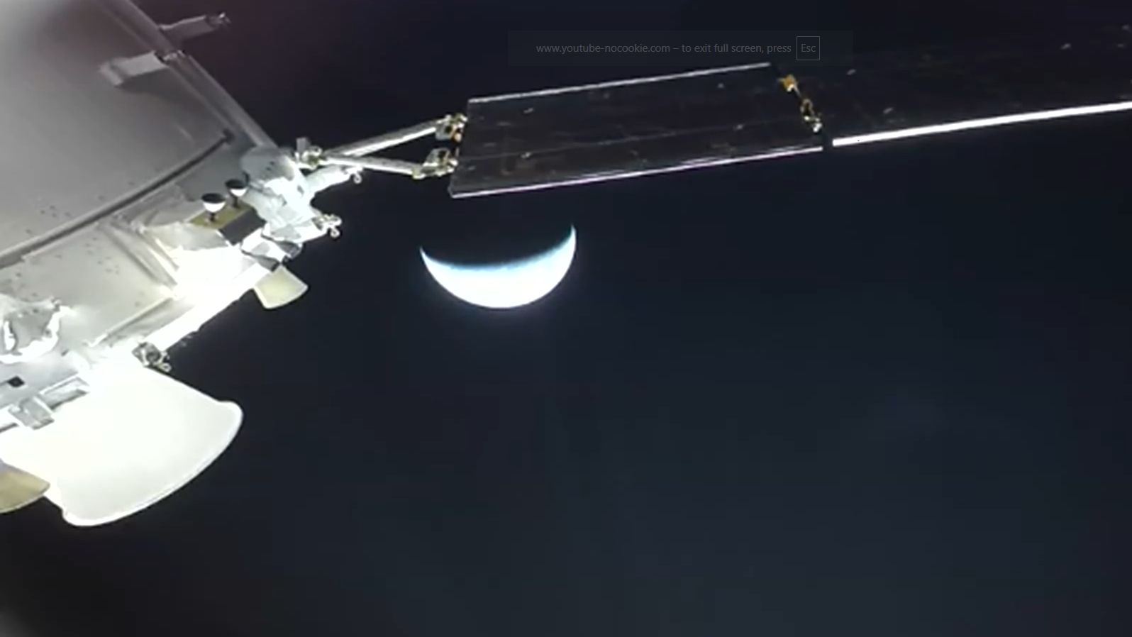 close up view showing orion spacecraft approaching each, appearing as a crescent.