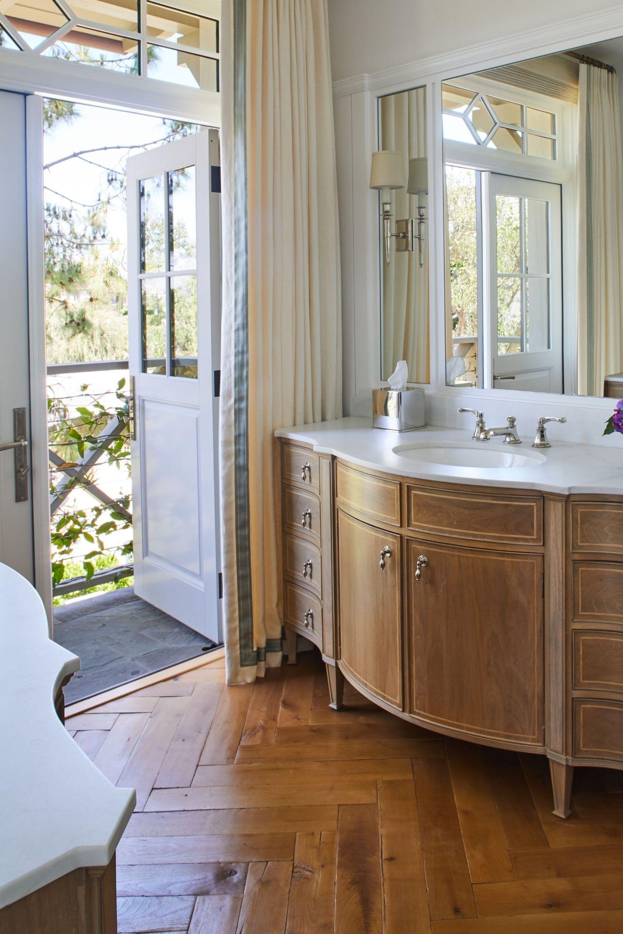 traditional bathroom with oak vanity unit and original wooden floorboards in a herringbone pattern