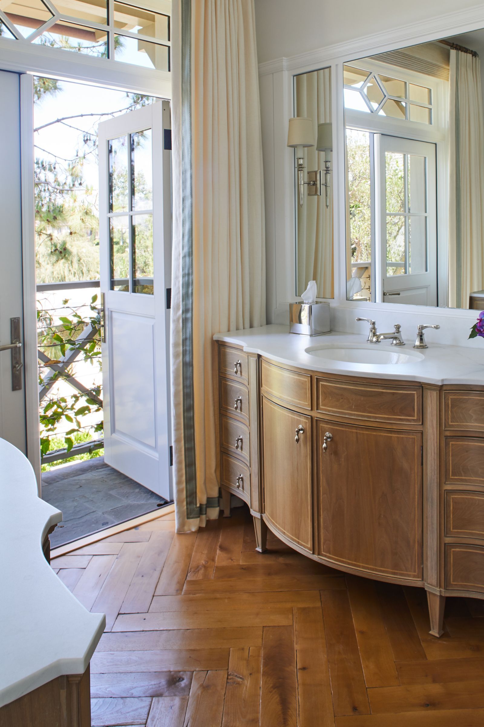 traditional bathroom with oak vanity unit and original wooden floorboards in a herringbone pattern