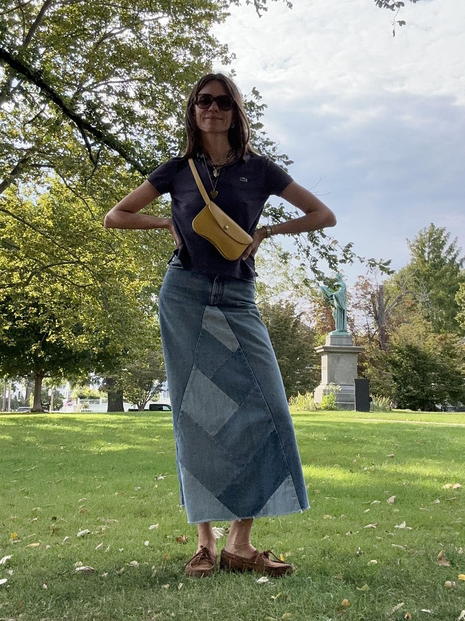 Julia Gall styles a short sleeve polo with a long denim skirt and boat shoes