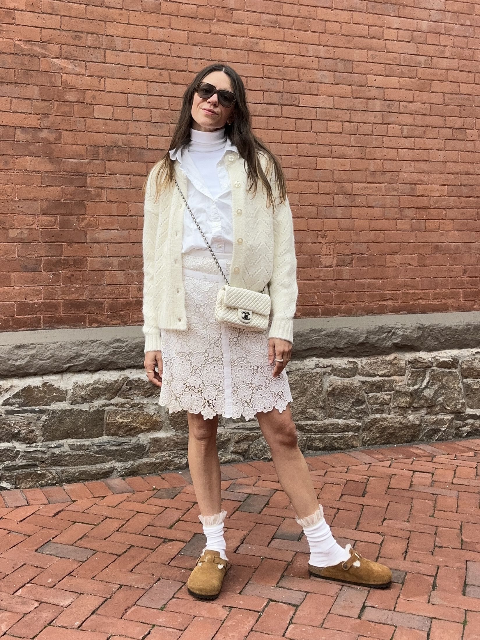 Julia Gall styles a white lace mini skirt with shades of white and bare legs