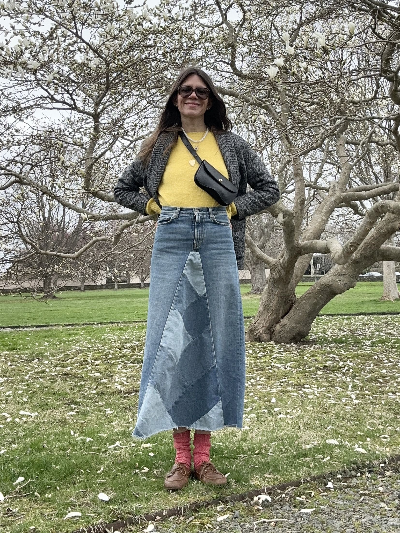 Julia Gall styles a long denim skirt with a yellow sweater and boat shoes