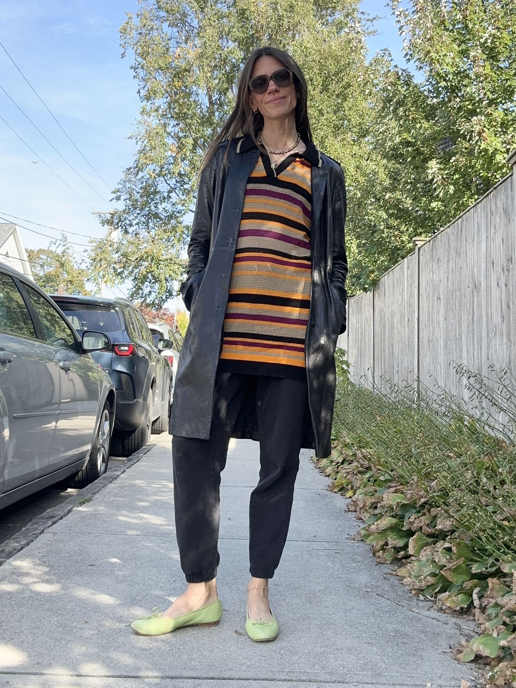 Julia Gall wears a striped dress over sweatpants with green ballet pumps