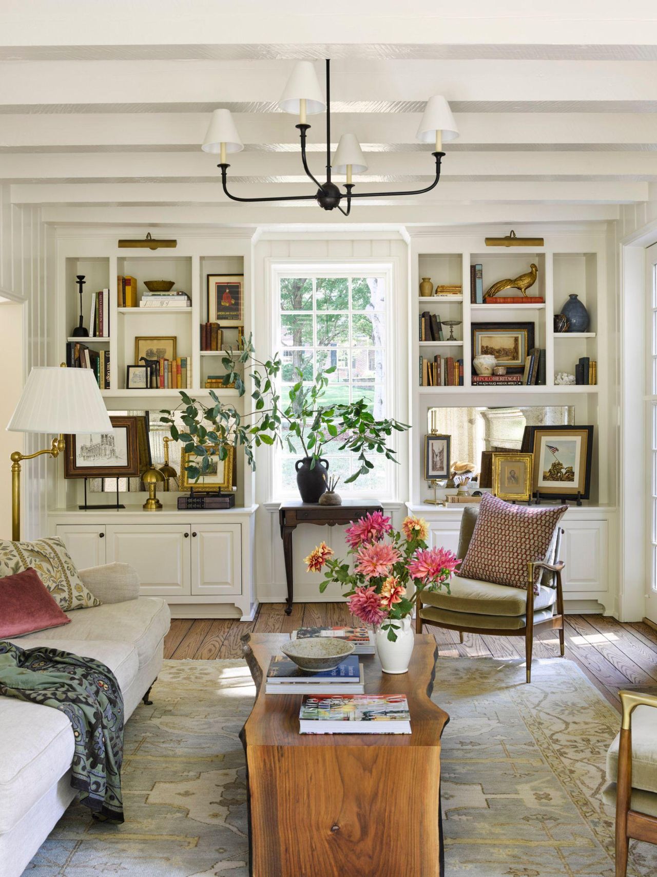 side by side living room interiors with a vintage collected neutral living room on the left and a soft green color drenched living room on the right with an L shaped couch