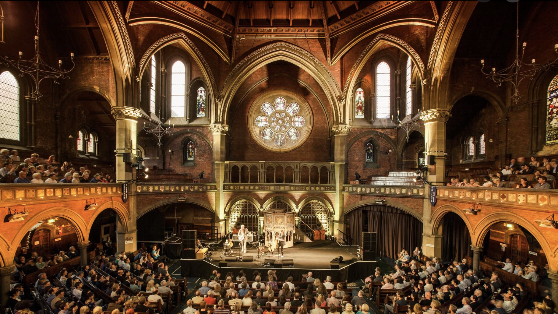an image of the interior of union chapel with a full crowd in watching an Alfred Hitchcock tribute