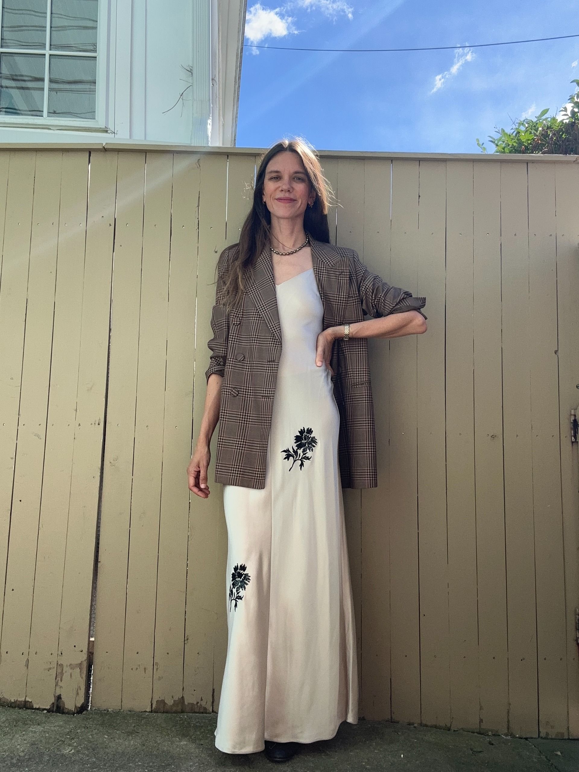 Julia Gall styles a long silky slip dress with a menswear-style blazer