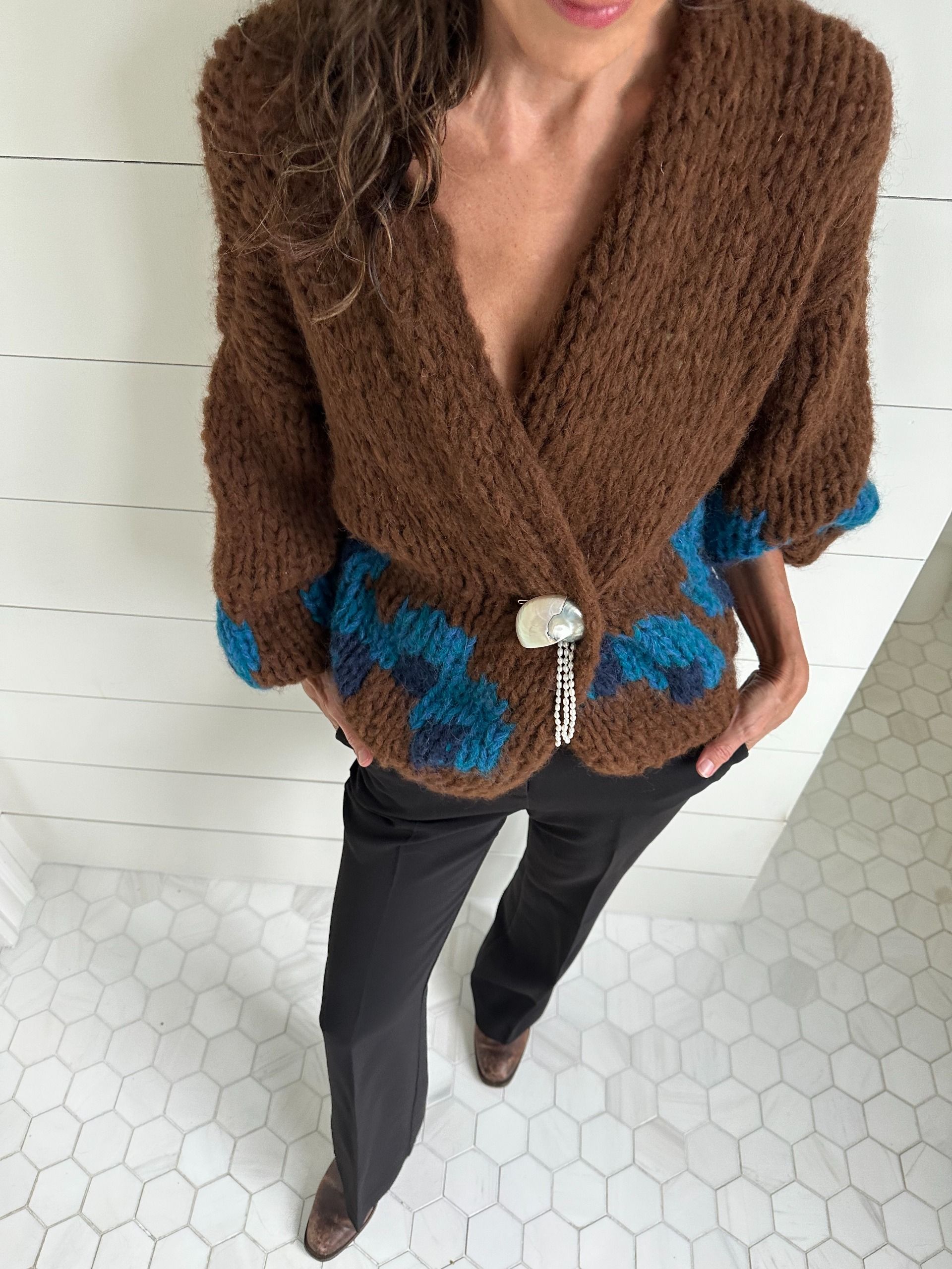 Larissa Mills wears petite pants with a statement cardigan