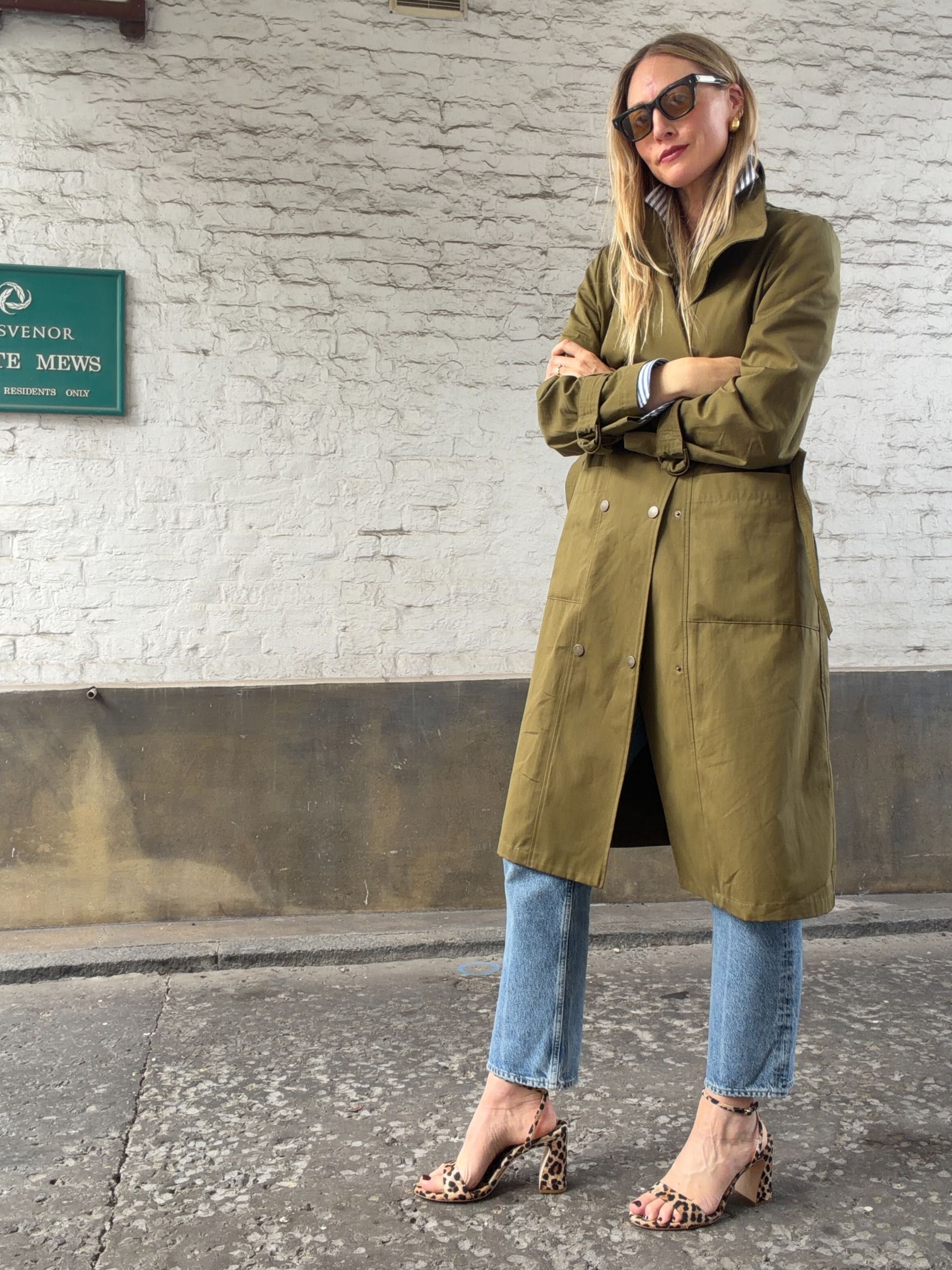 Brooke Ely Danielson styles mid heeled sandals in leopard print with an olive coat and jeans