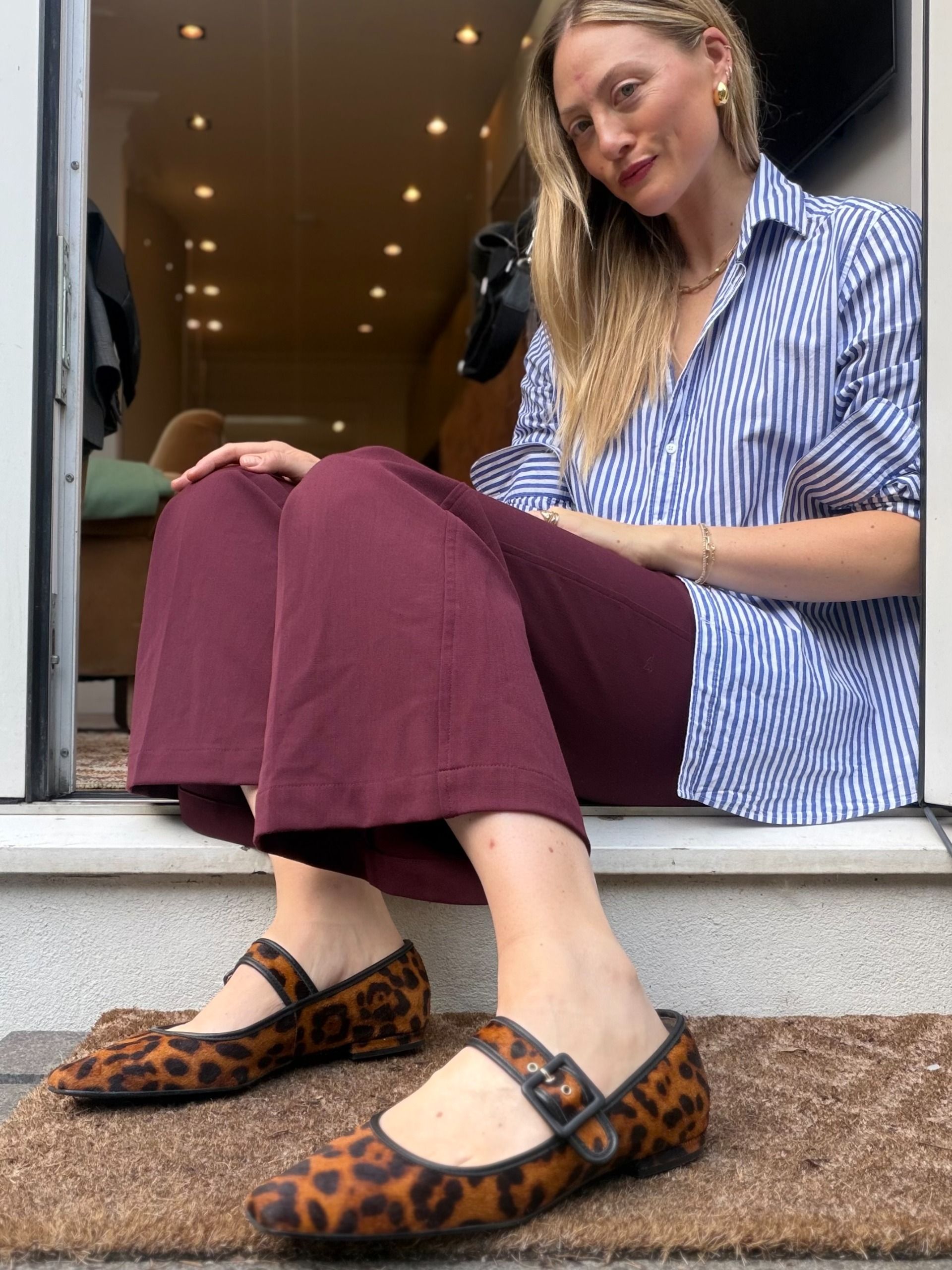 Brooke Ely Danielson styles leopard print flats with a striped button down and merlot pants