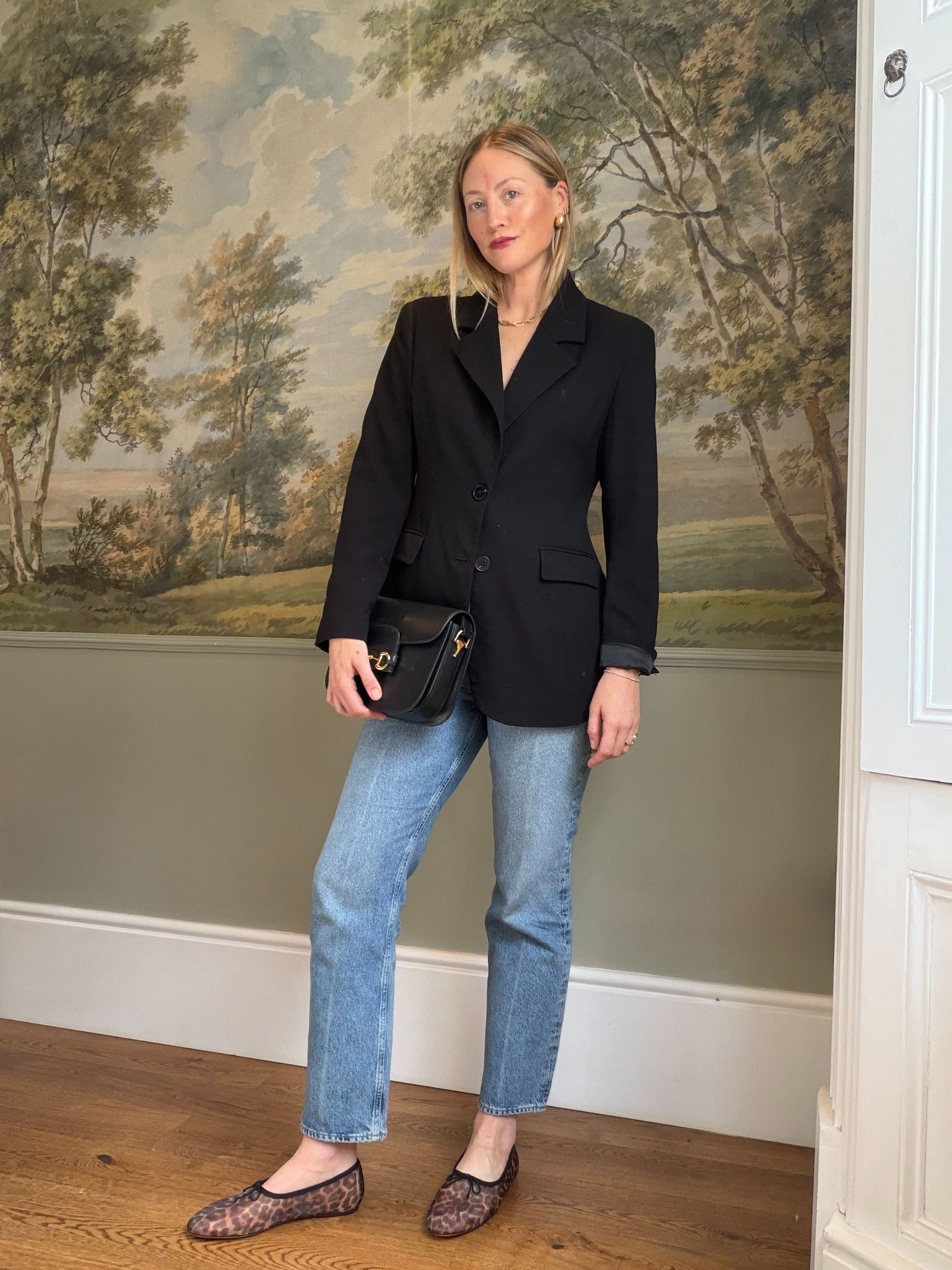Brooke Ely Danielson wears a black blazer, light jeans and sheer leopard flats