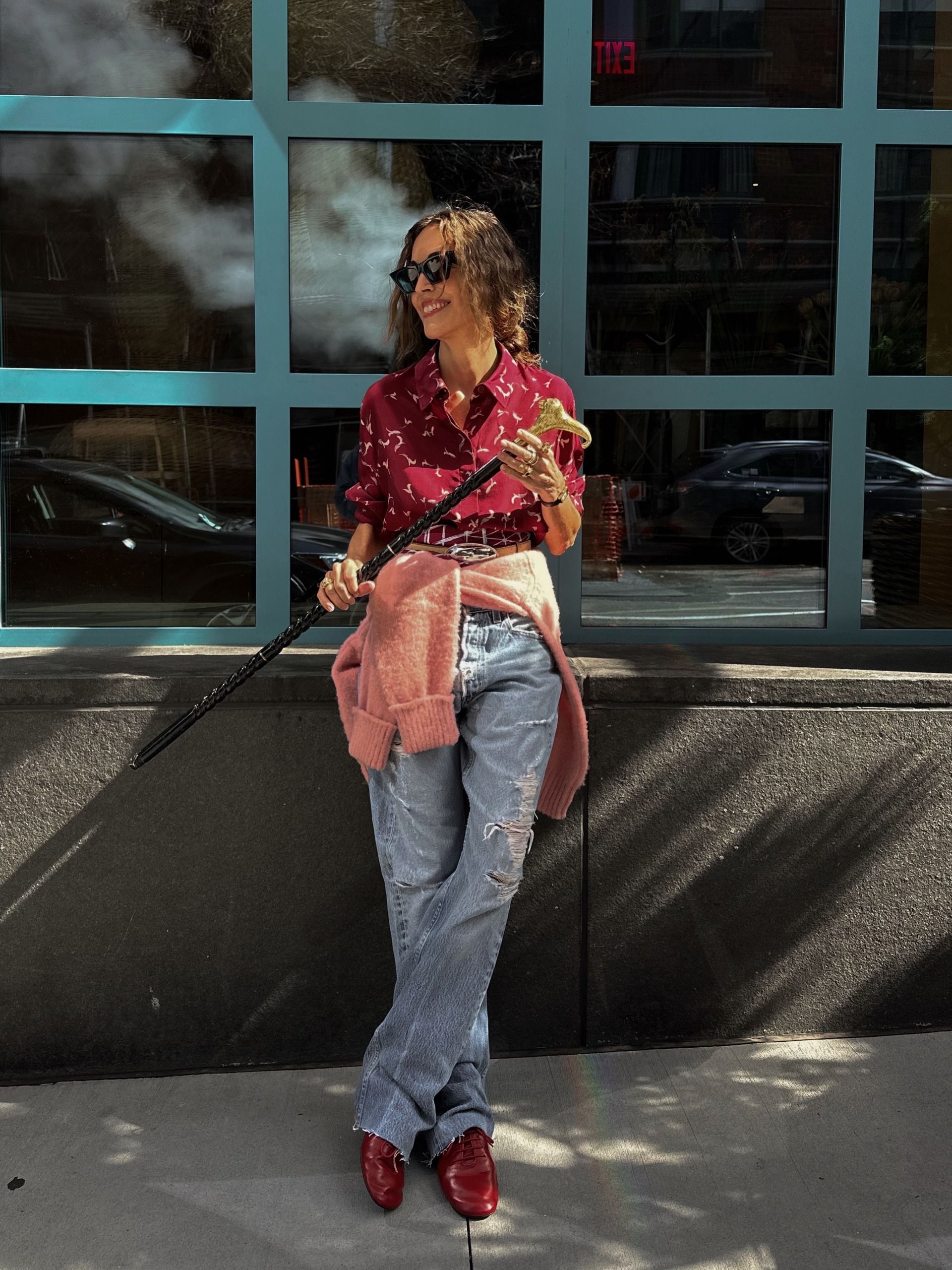 Larissa Mills demonstrates petite styling in distressed jeans with a red shirt and shoes