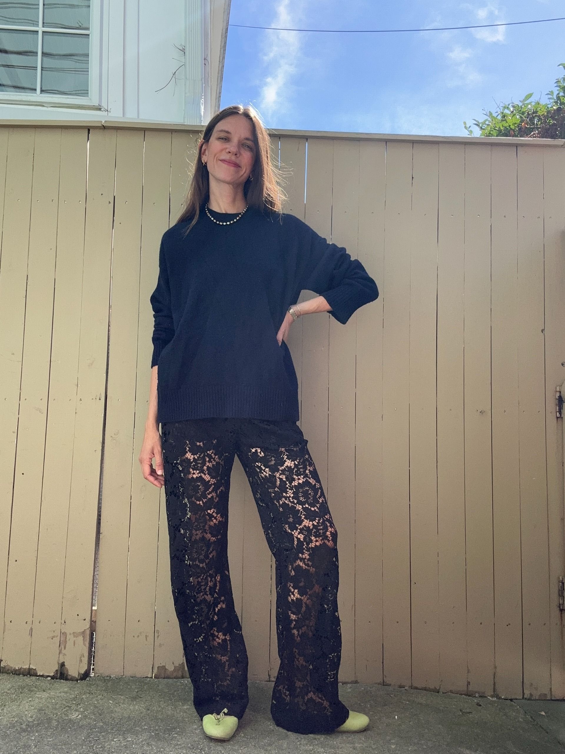 Julia Gall styles a navy crewneck with black lace pants and lime green ballet flats