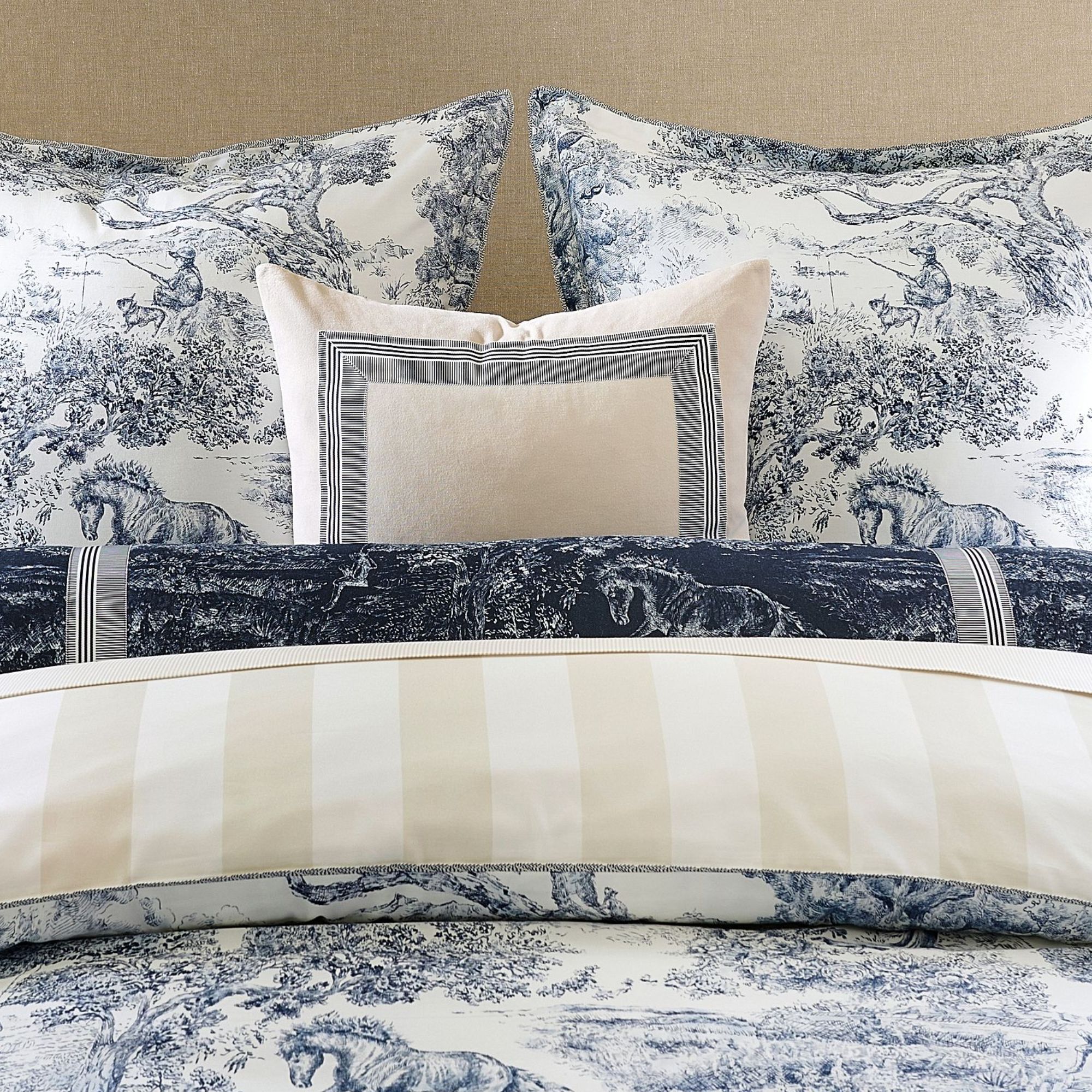 Blue toile bedding with cream reversible stripe print and cream cushion