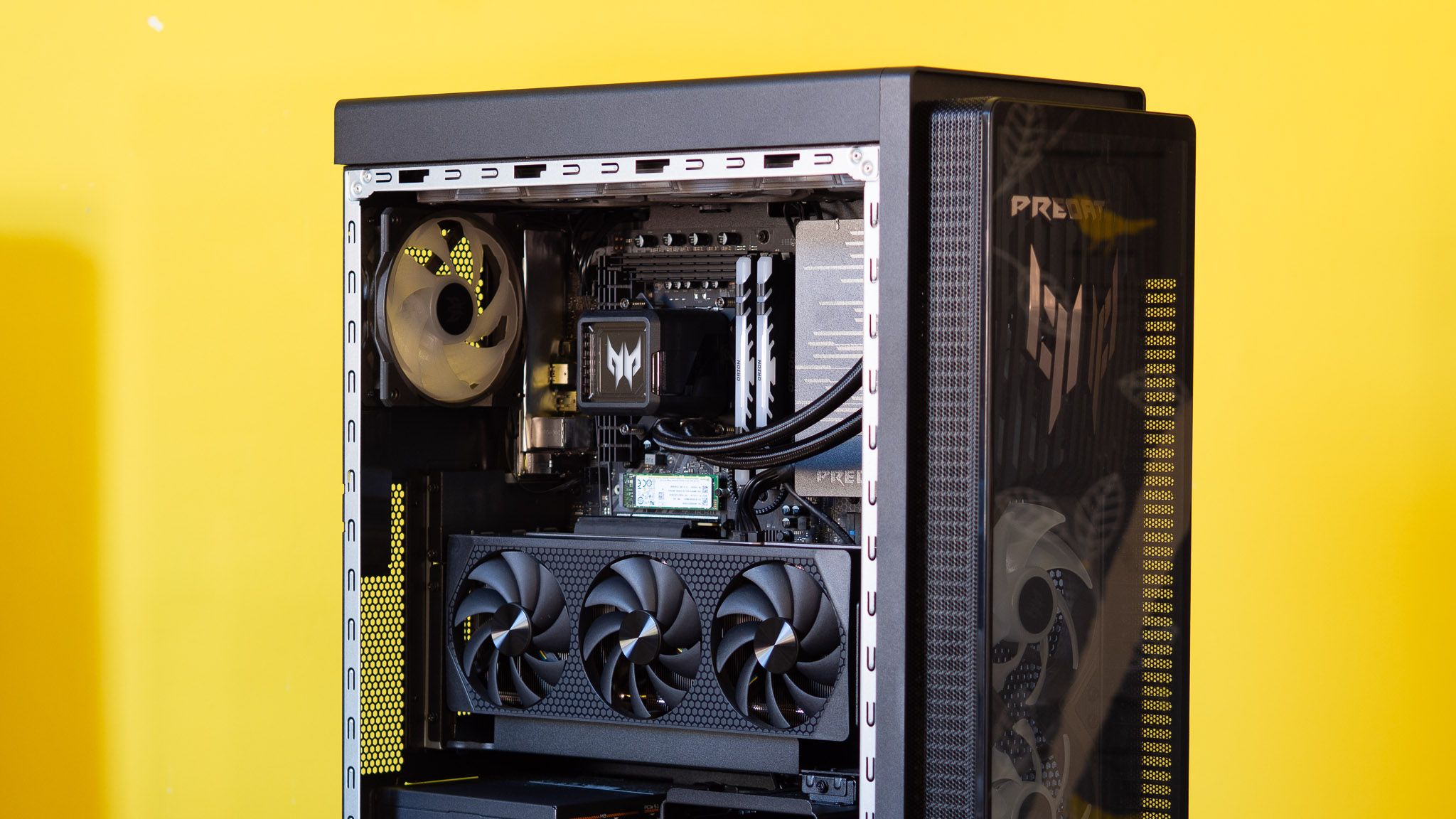 Acer Predator Orion 7000 gaming desktop PC on a wooden desk and yellow background