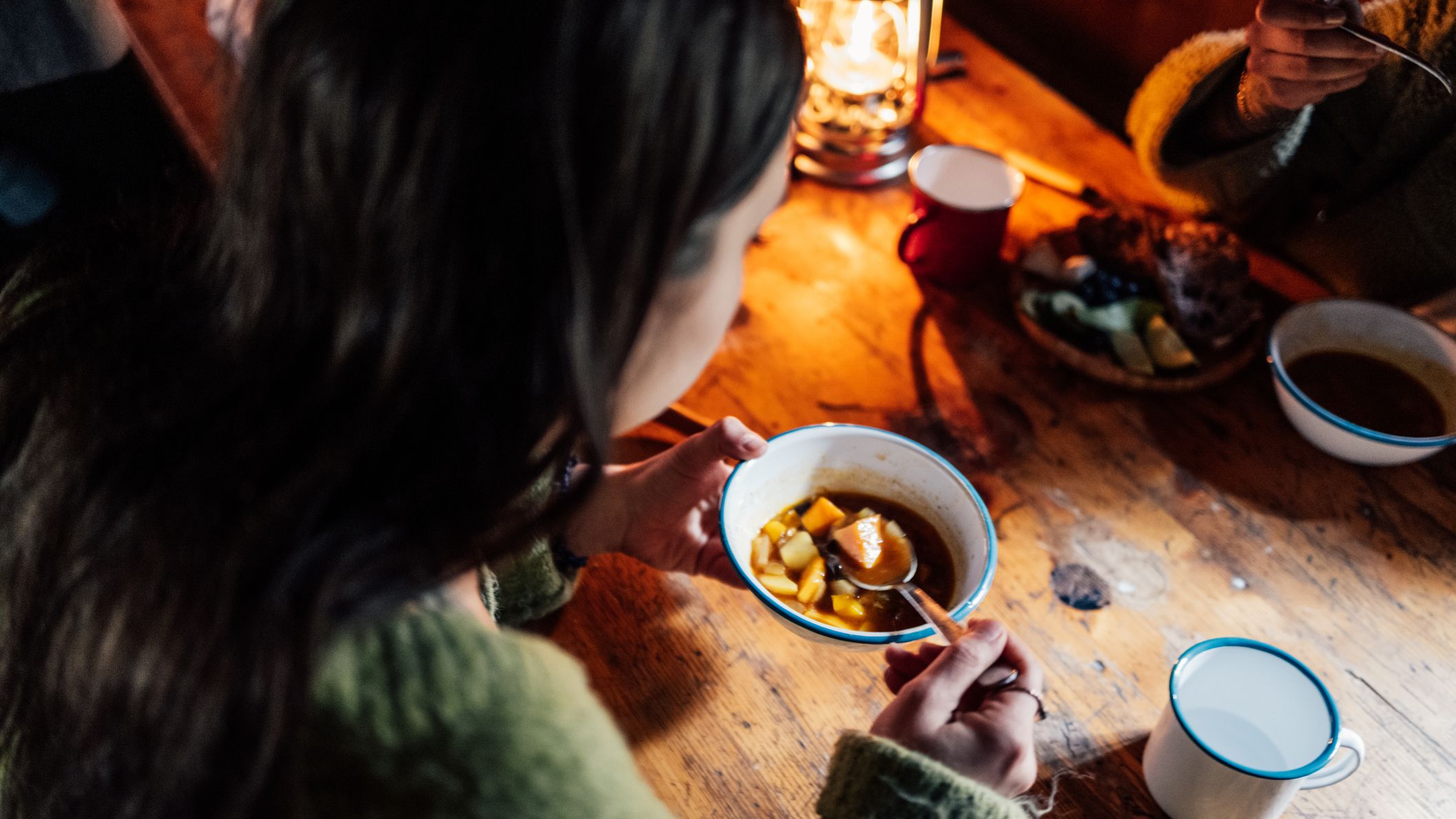 Woman eats a bowl of vegetable soup