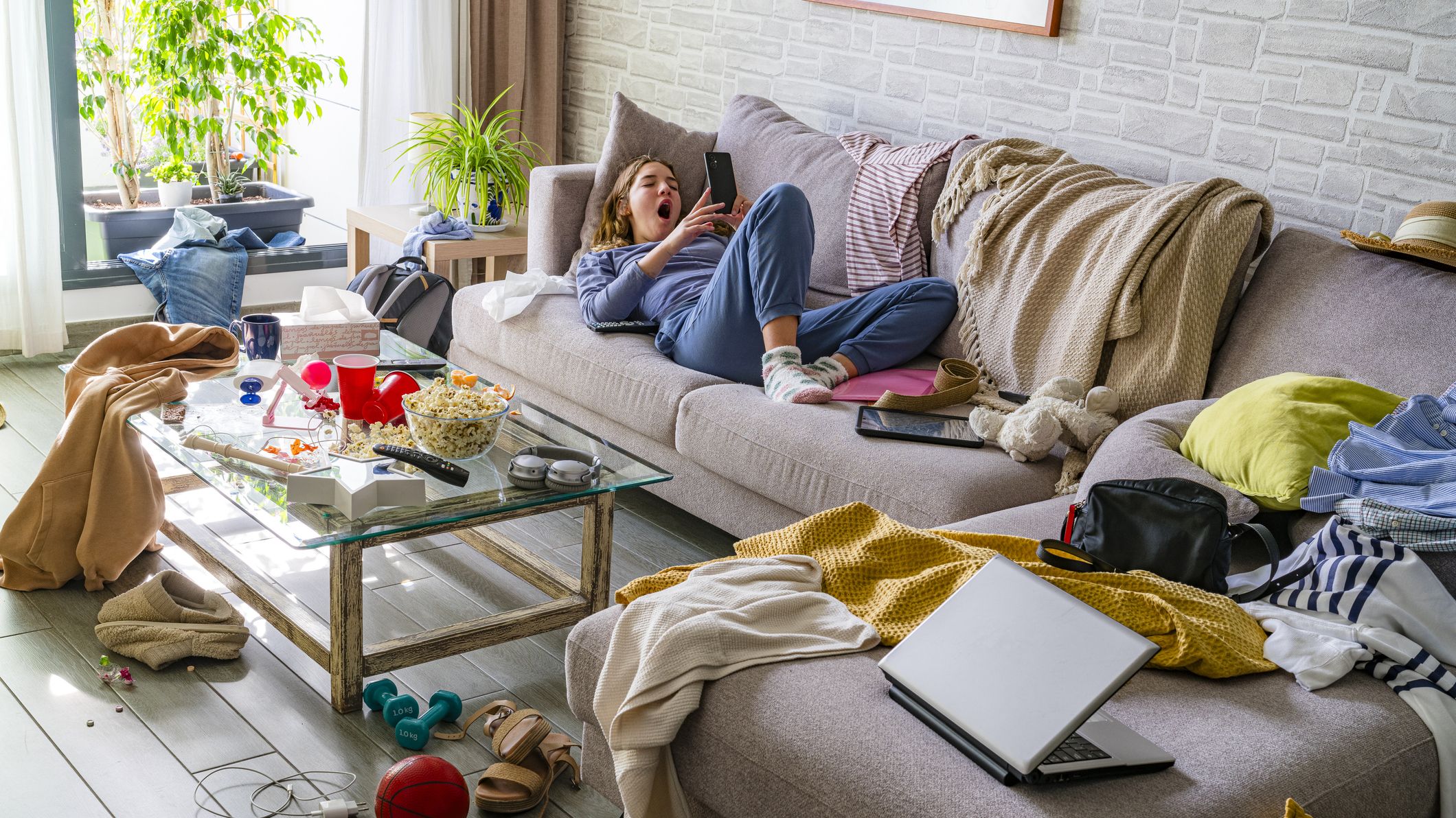 A teenager looking at their cell phone on a Saturday morning.