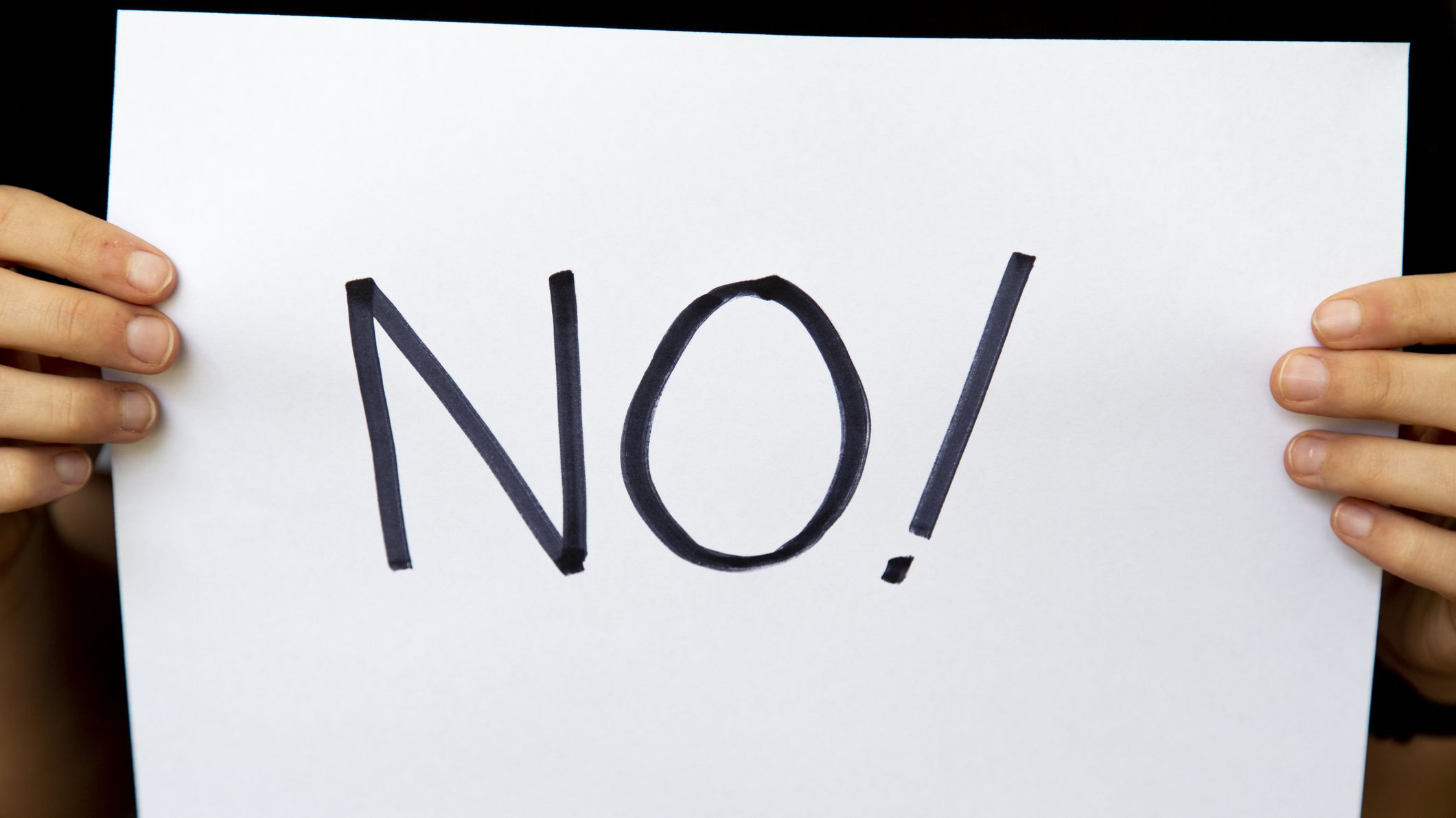 A protestor holding a no sign.