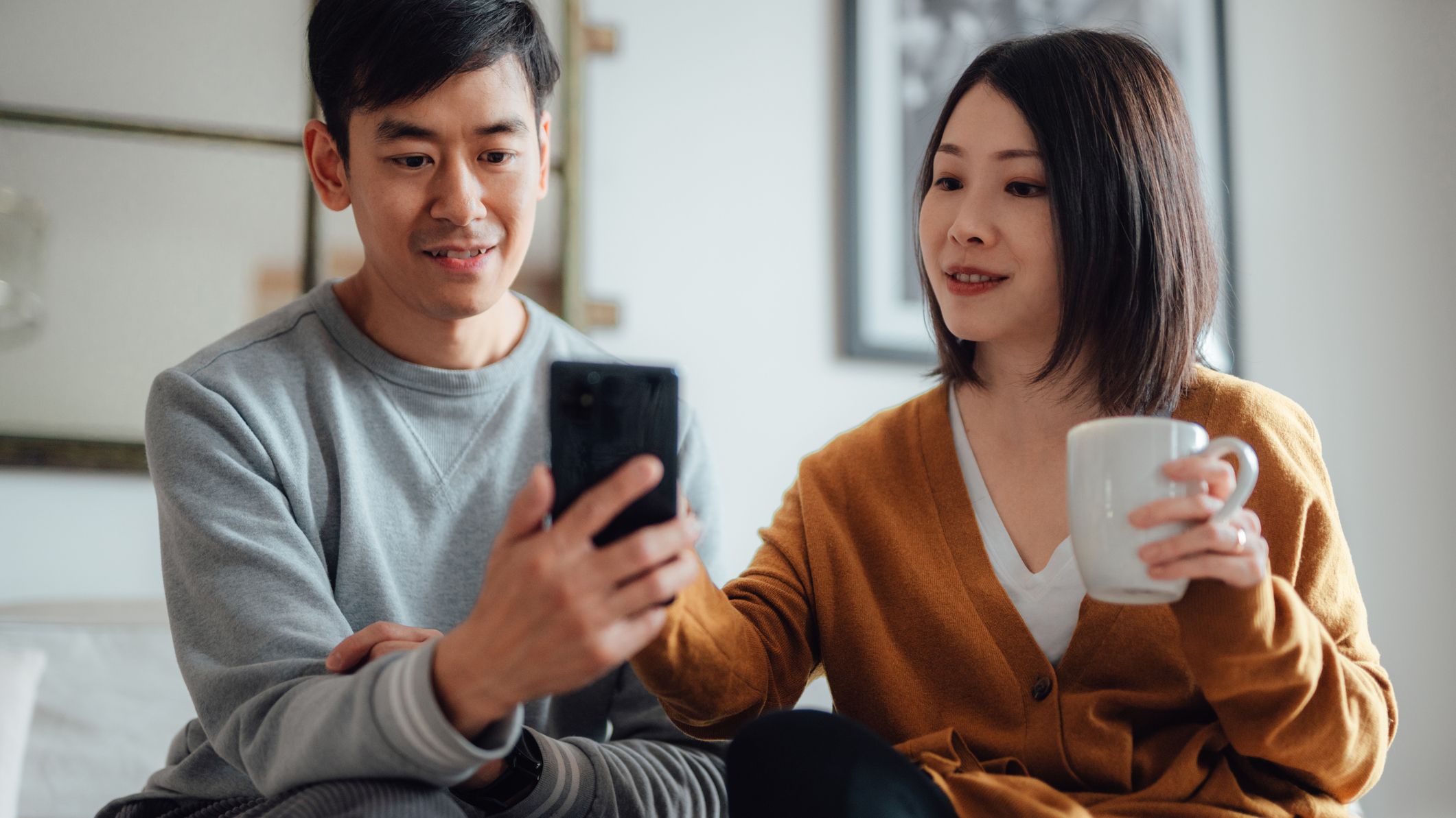 a couple budgeting on a smartphone