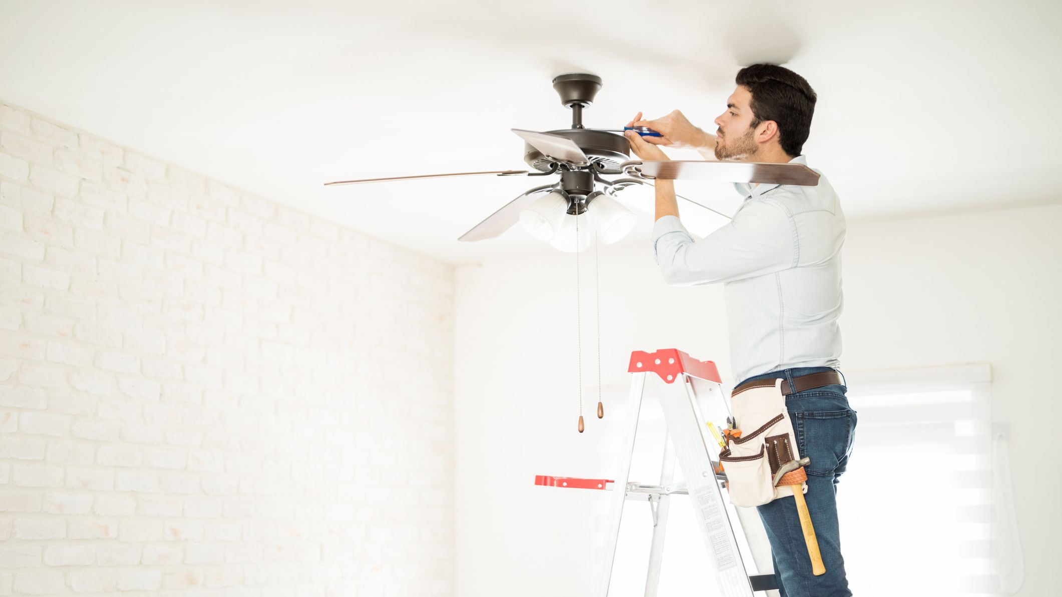 Electrician fixing a ceiling fan