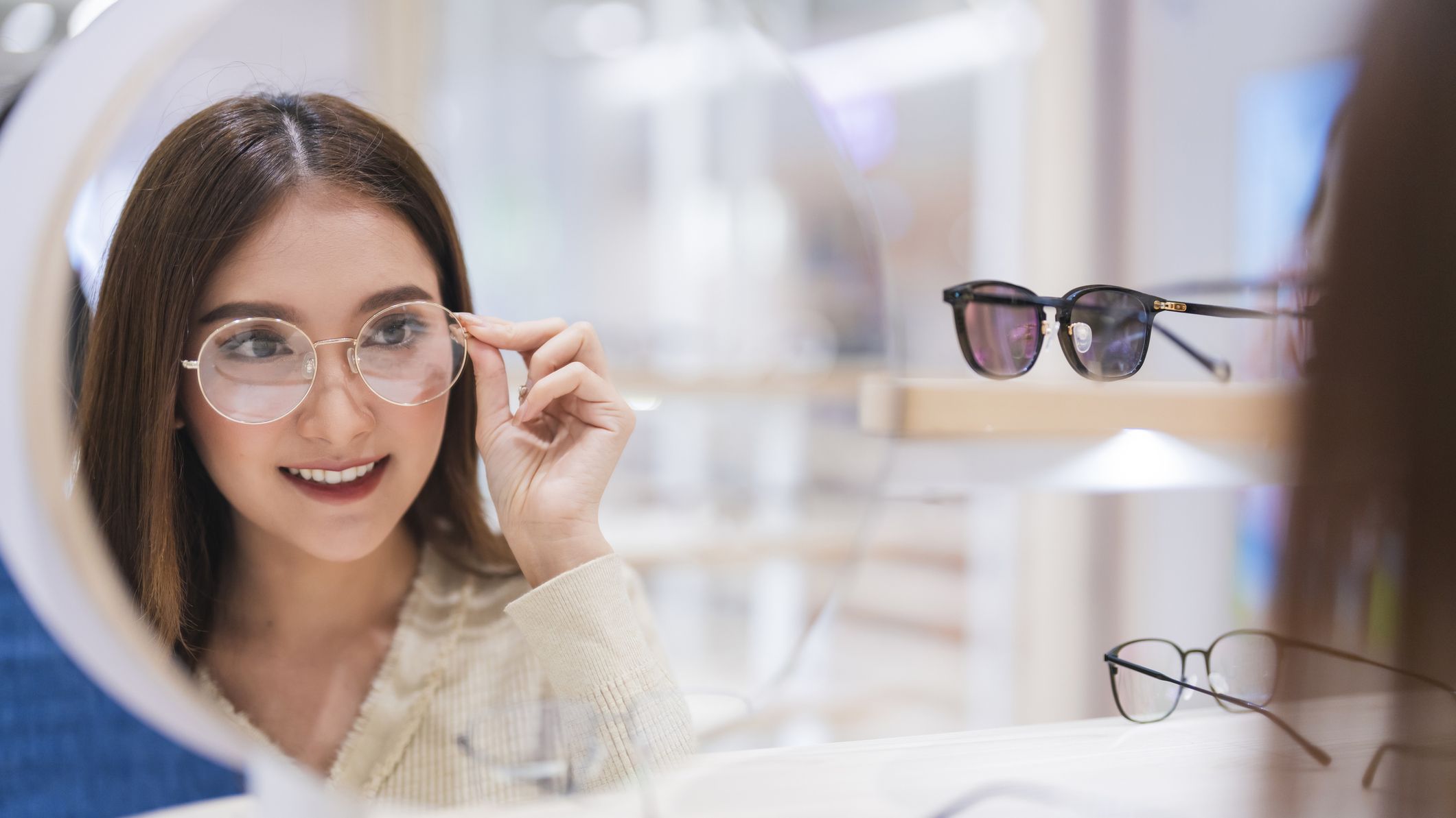 A woman trying on eye glasses