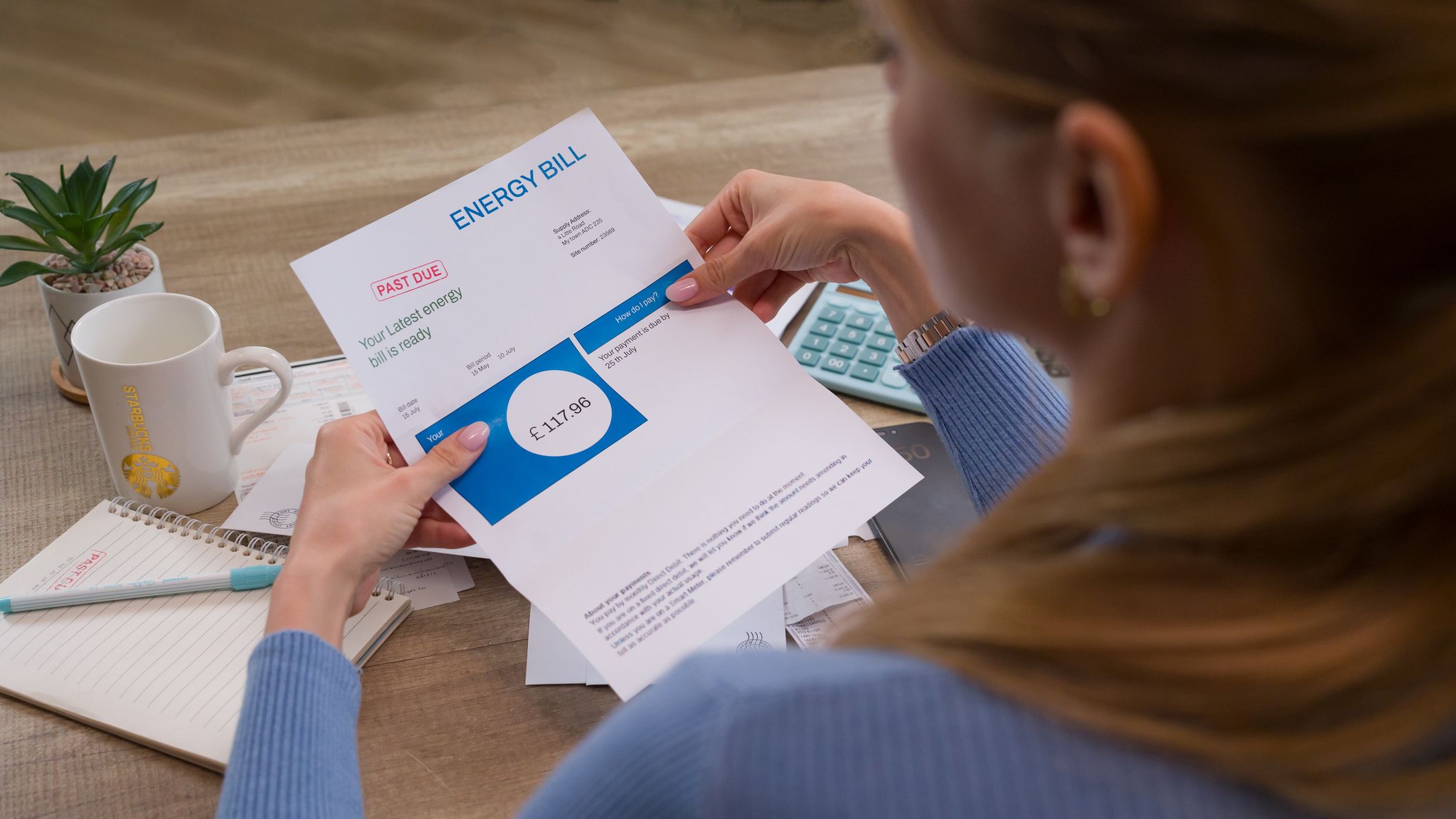 a woman reads her electricity bill