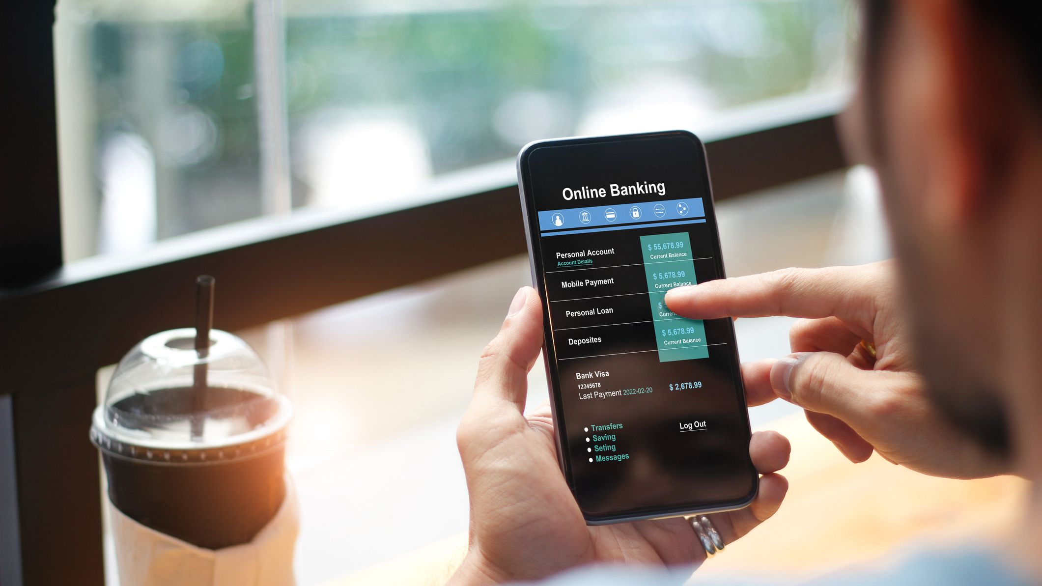 Man using online banking technology on touch screen device.