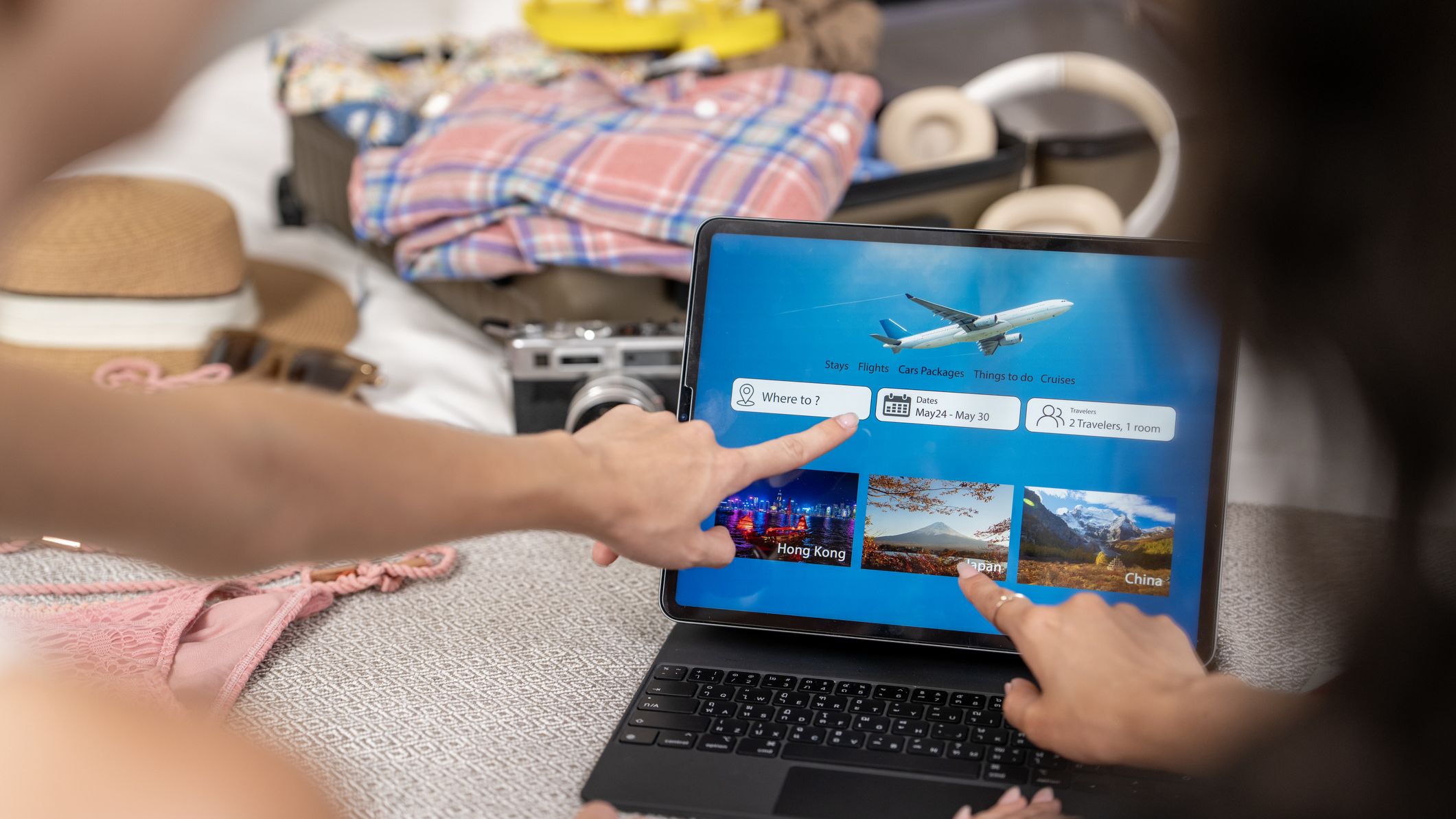 a couple booking travel on a laptop