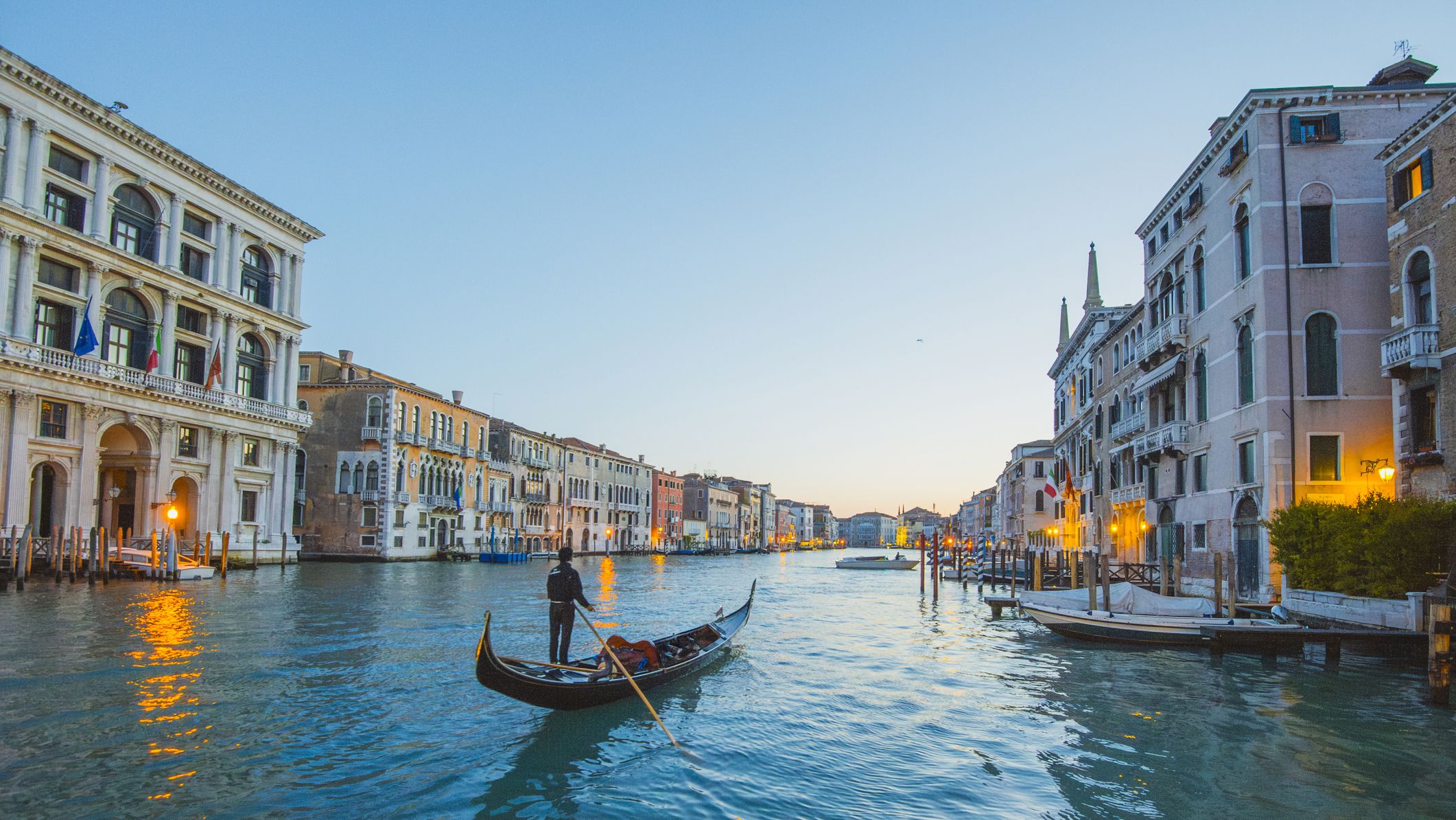 A gondolier on a peaceful canal in Venice, Italy.