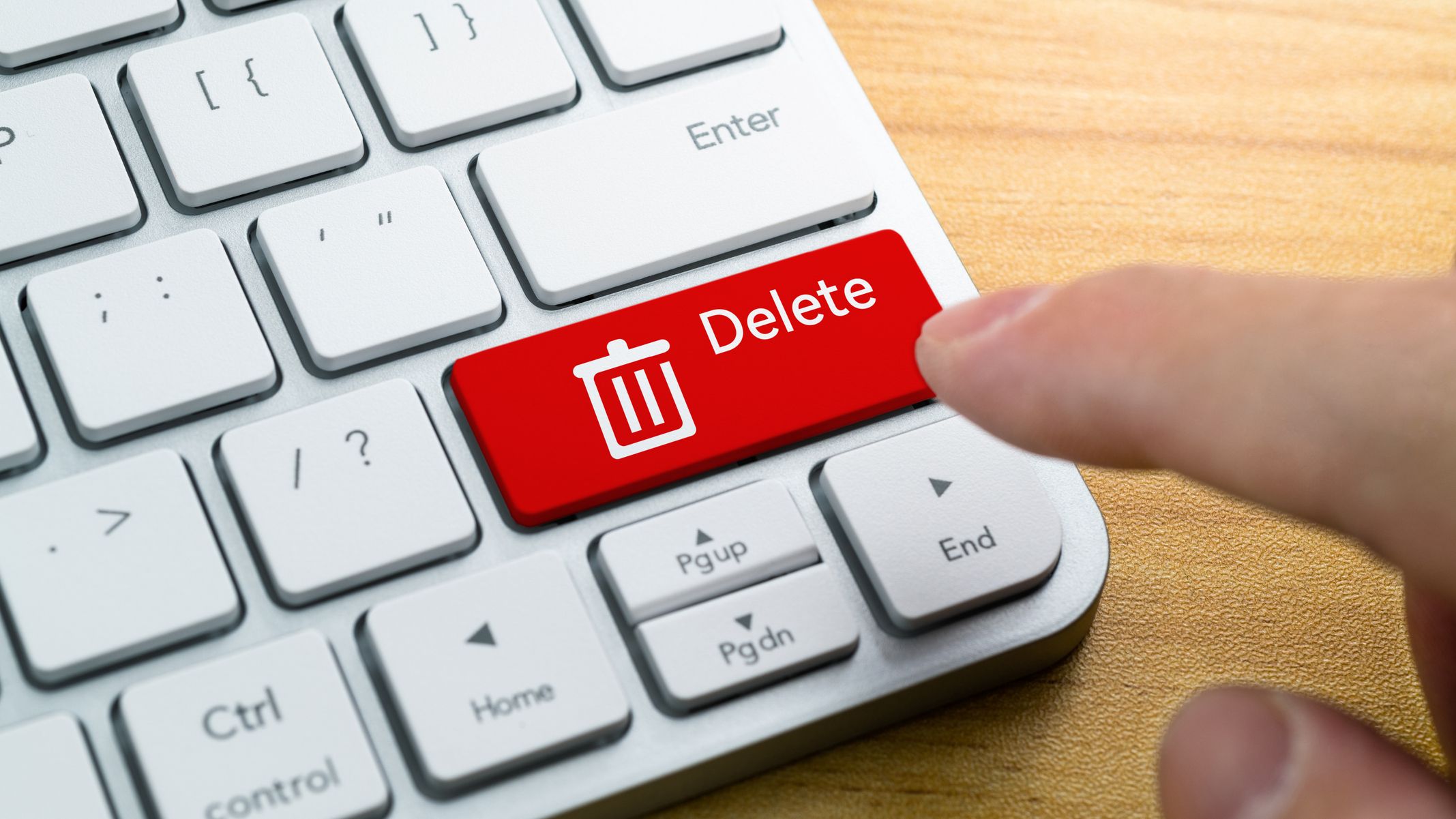 Human hand press the button with word delete