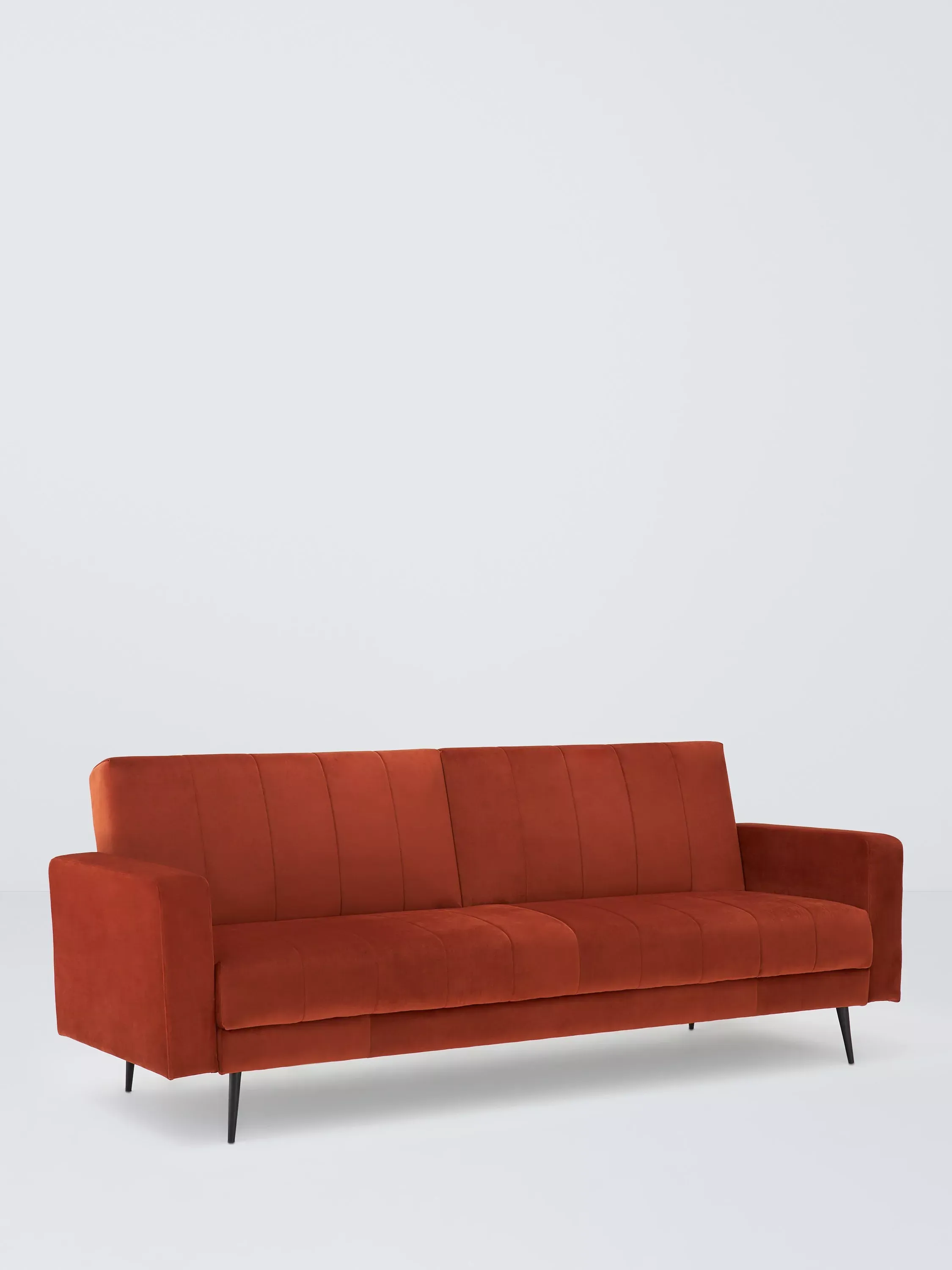 Rust orange velvet sofa bed with high armrests