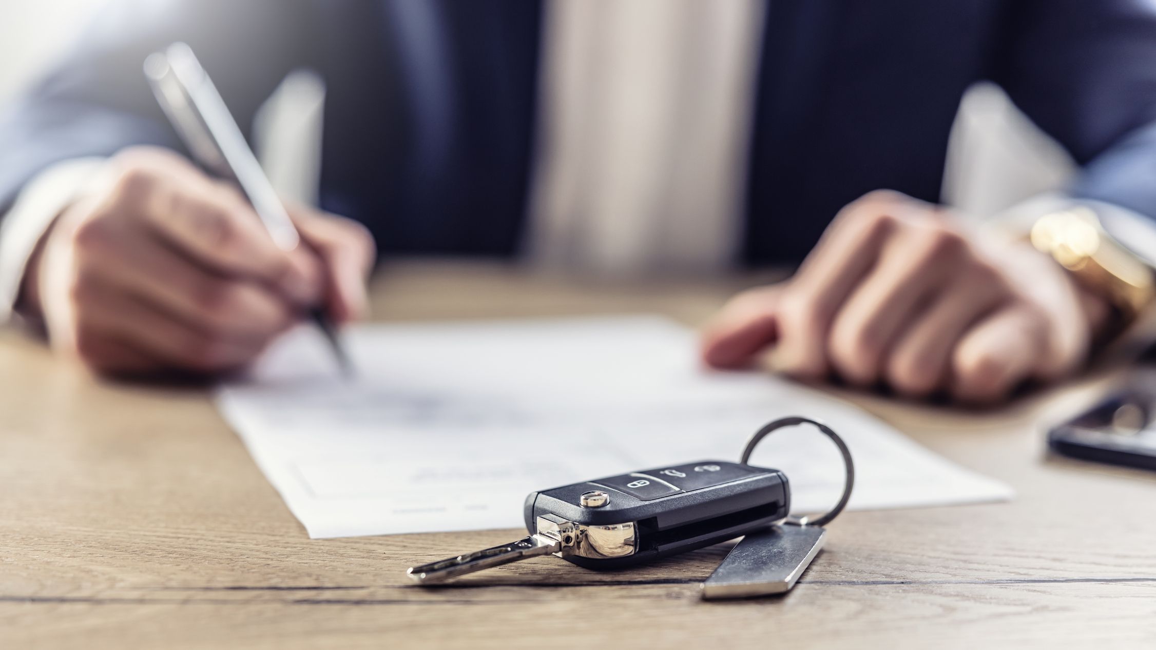 The agent signs a contract for the purchase or Leasing of a new car.