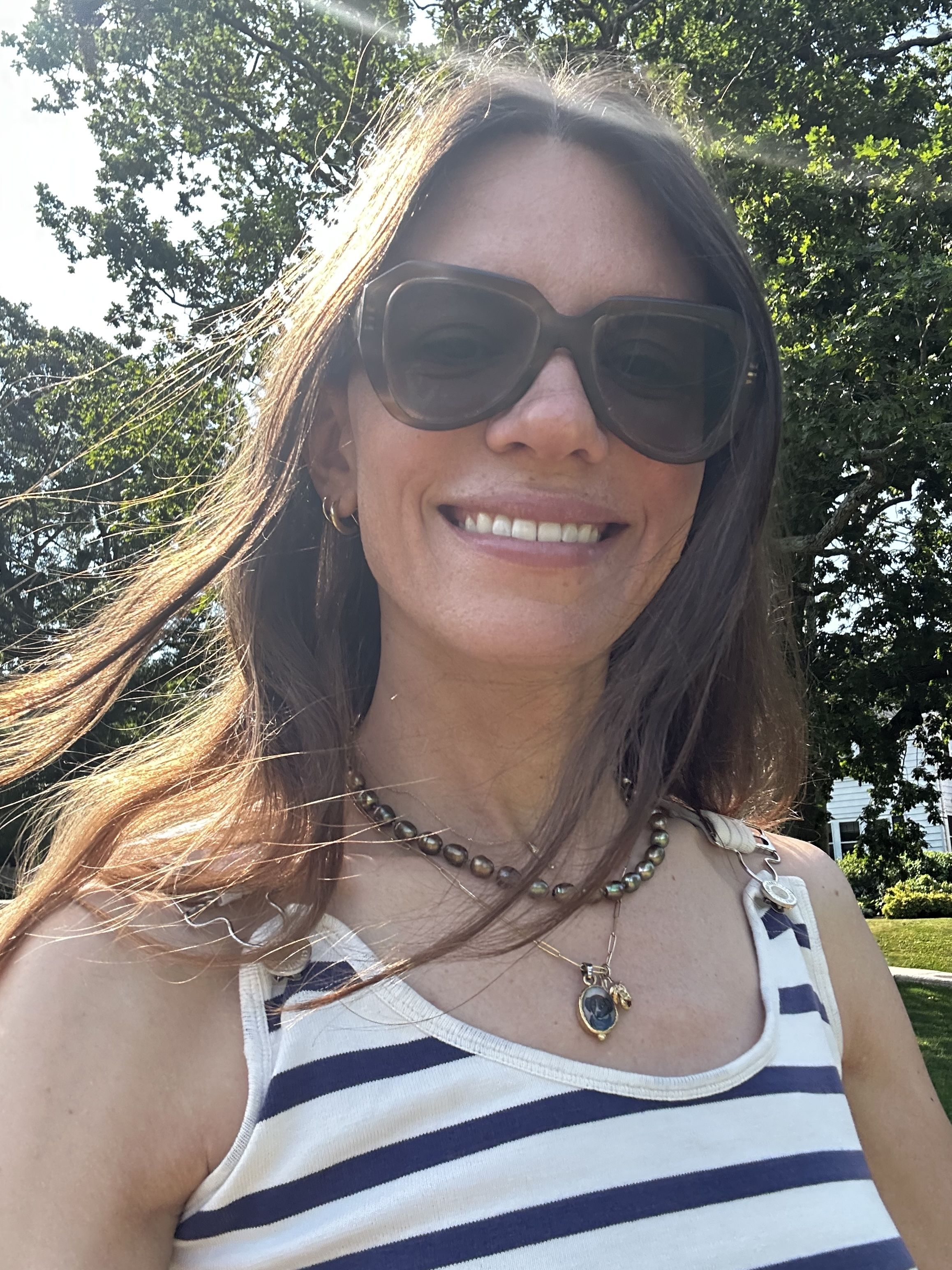 Julia Gall wears a strand of dark pearls layered with a pendant