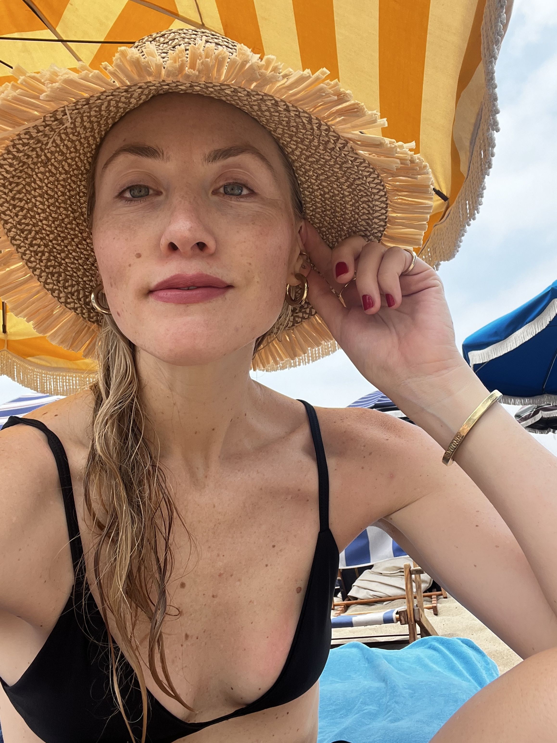 Brooke Ely Danielson wears a woven sunhat with a black bikini