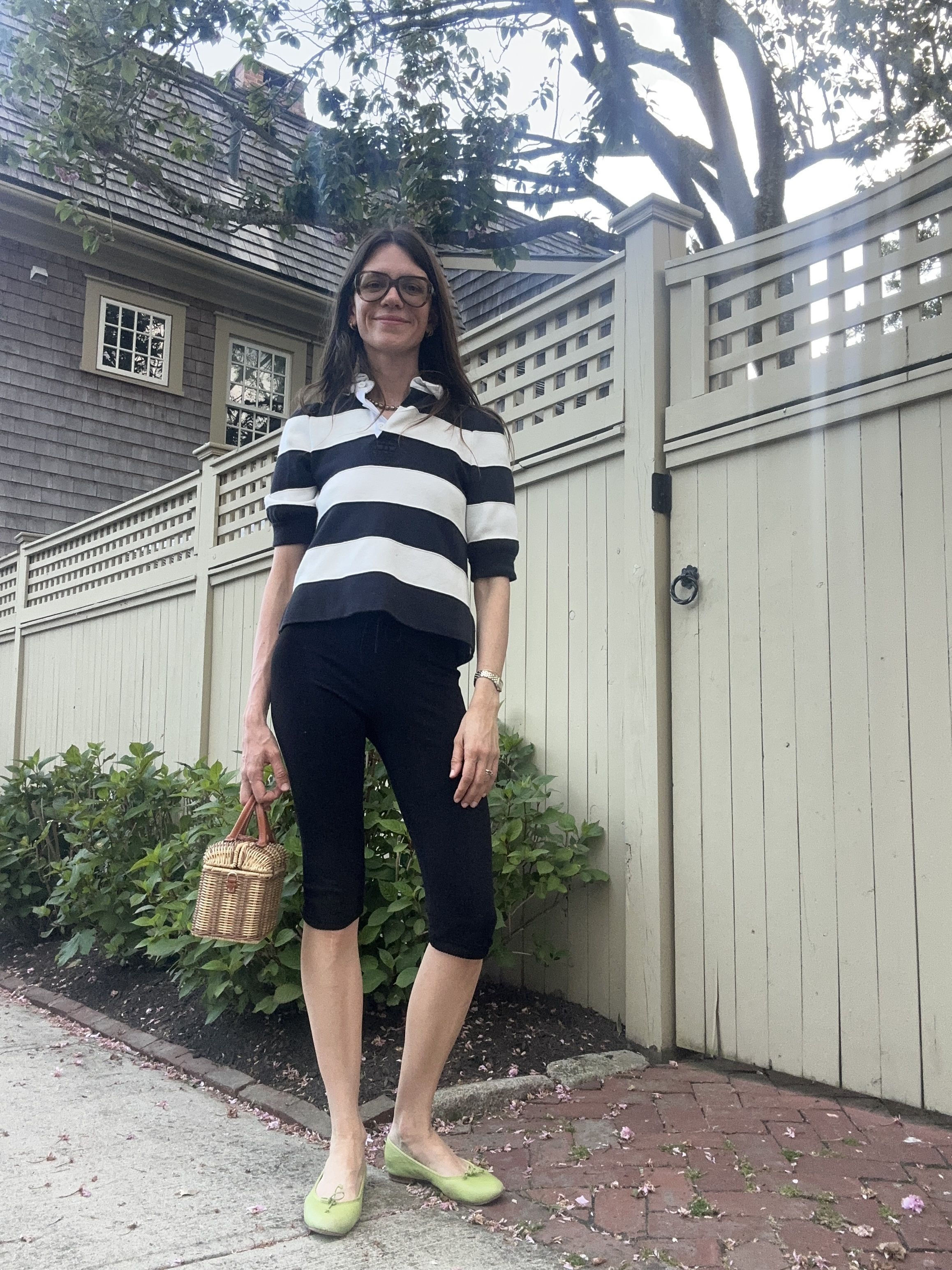 Julia Gall styles black capris with a cropped rugby top, basket bag and lime green ballet flats