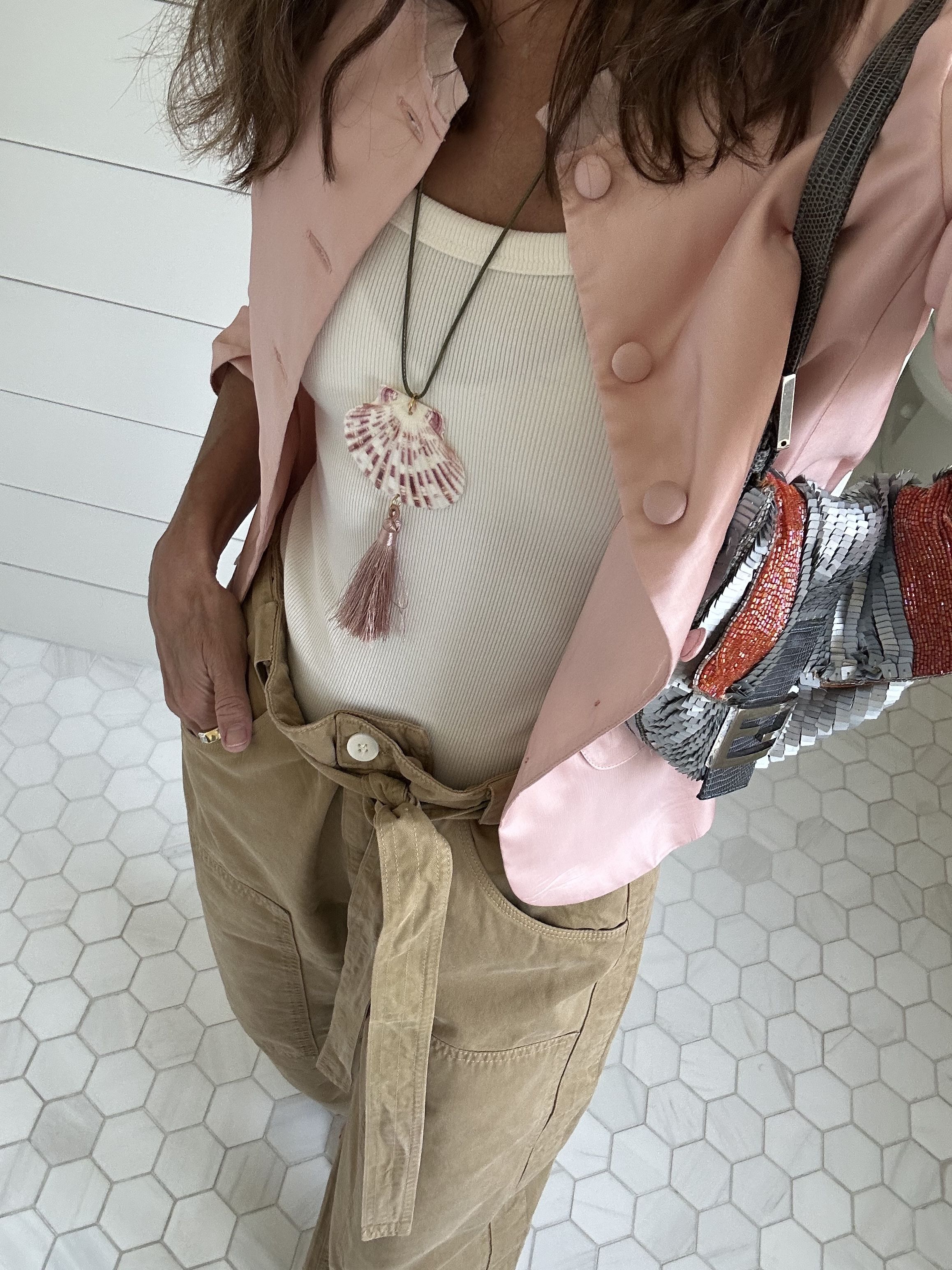 Larissa Mills often wear pants to graduation ceremonies; pictured here in tan pants and a pink jacket