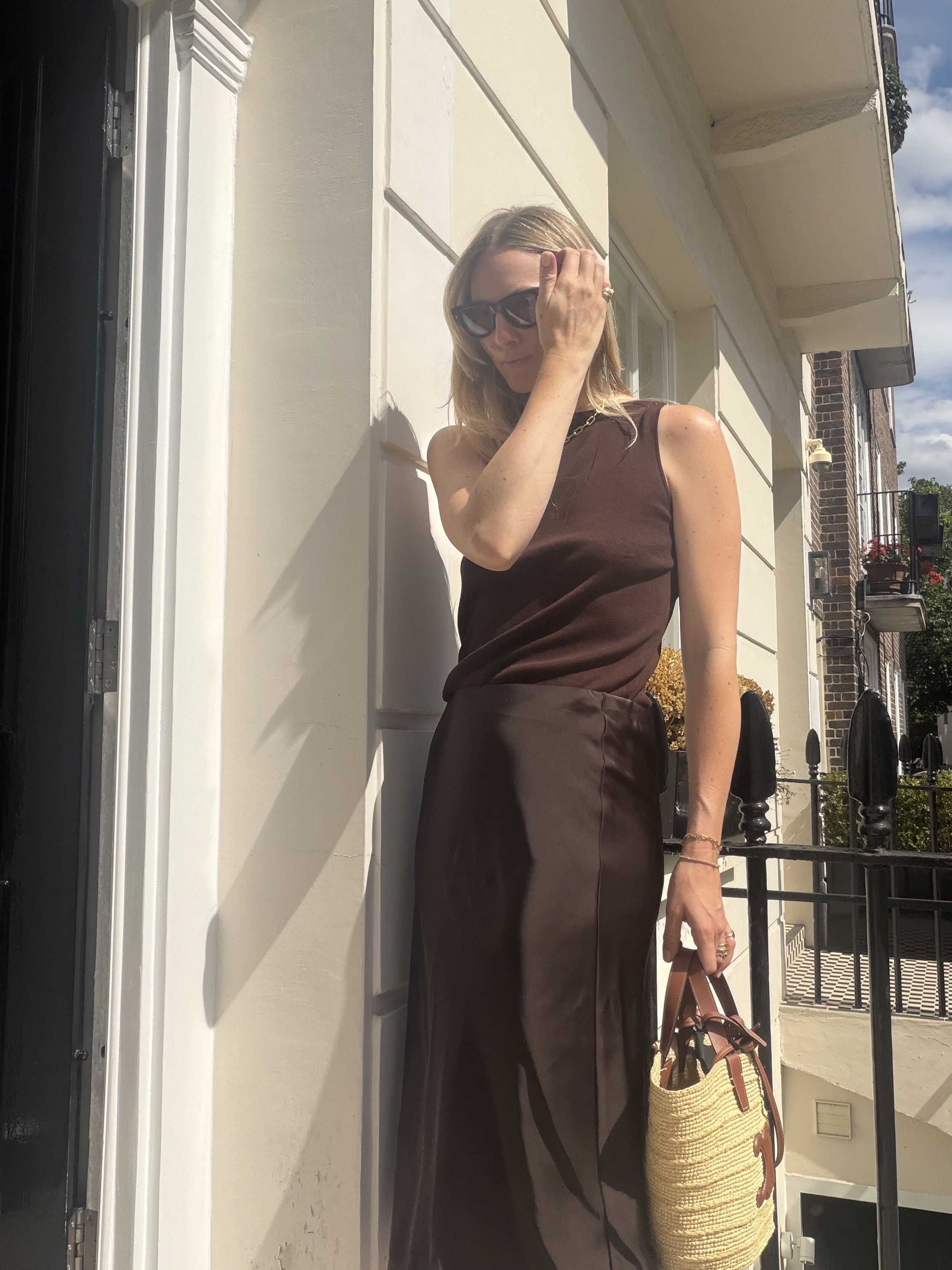 Brooke Ely Danielson models a summer look in shades of brown featuring a knit tank