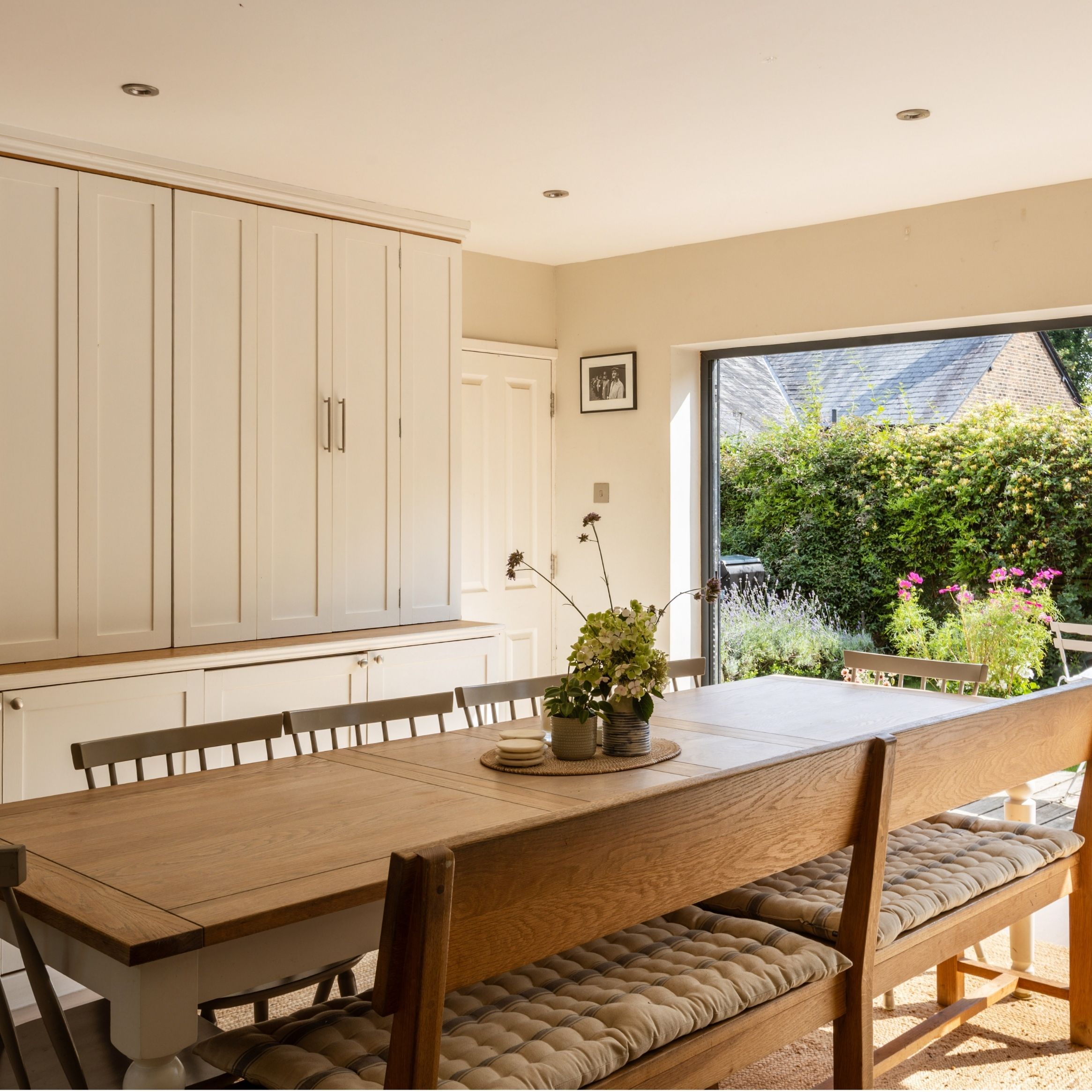 Dining area with built-in cabinets and large wooden table
