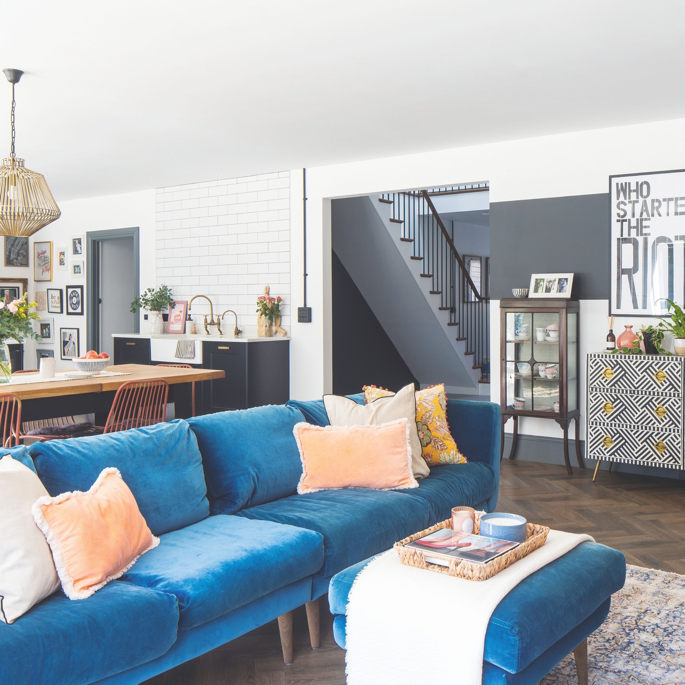 Open plan living room, kitchen and dining room with statement blue velvet sofa