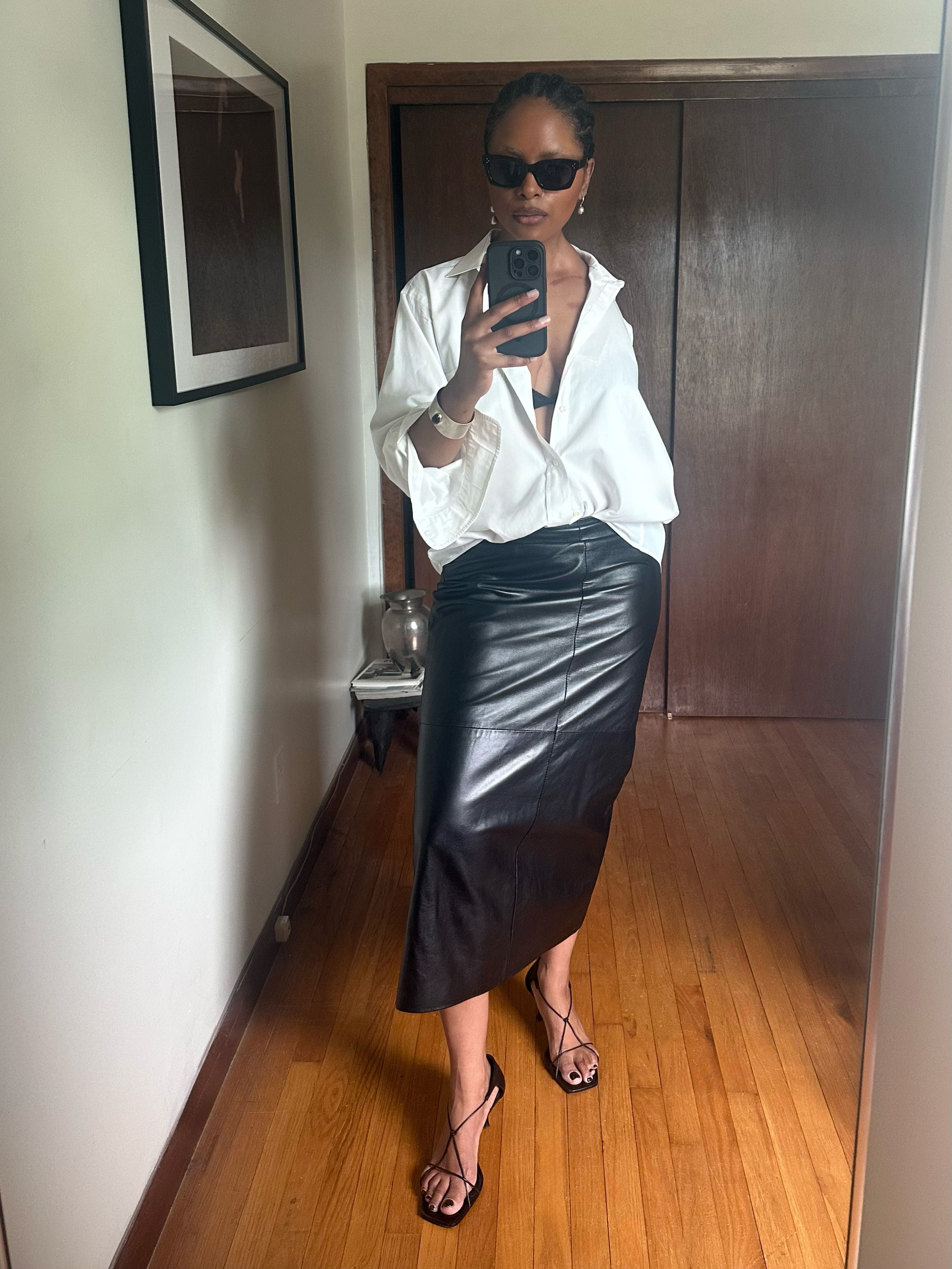 Maya Moore shows off her white button-down and black leather skirt outfit formula