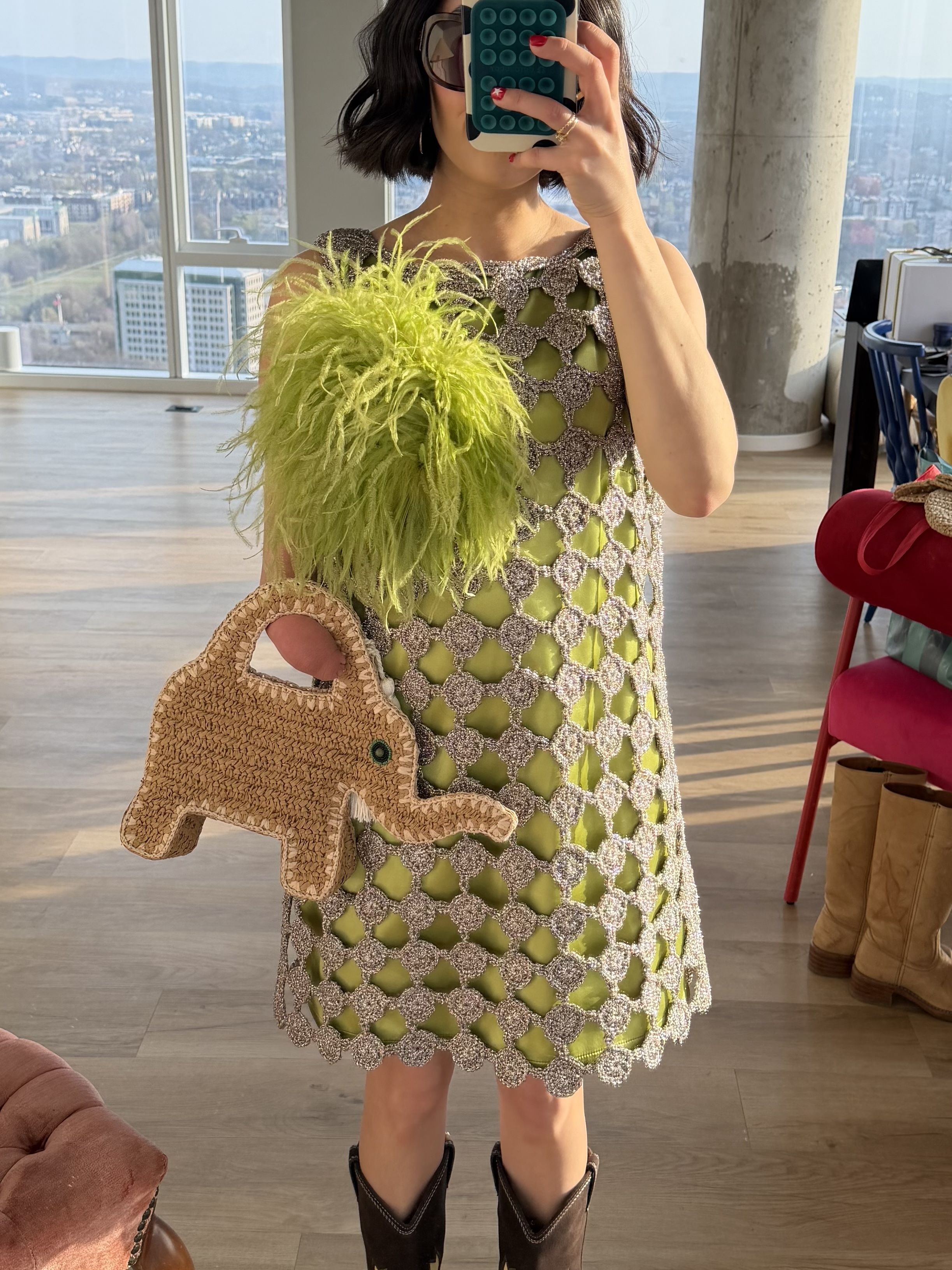 April Lockhart styles a textured lime green dress with a matching feather brooch and elephant woven bag