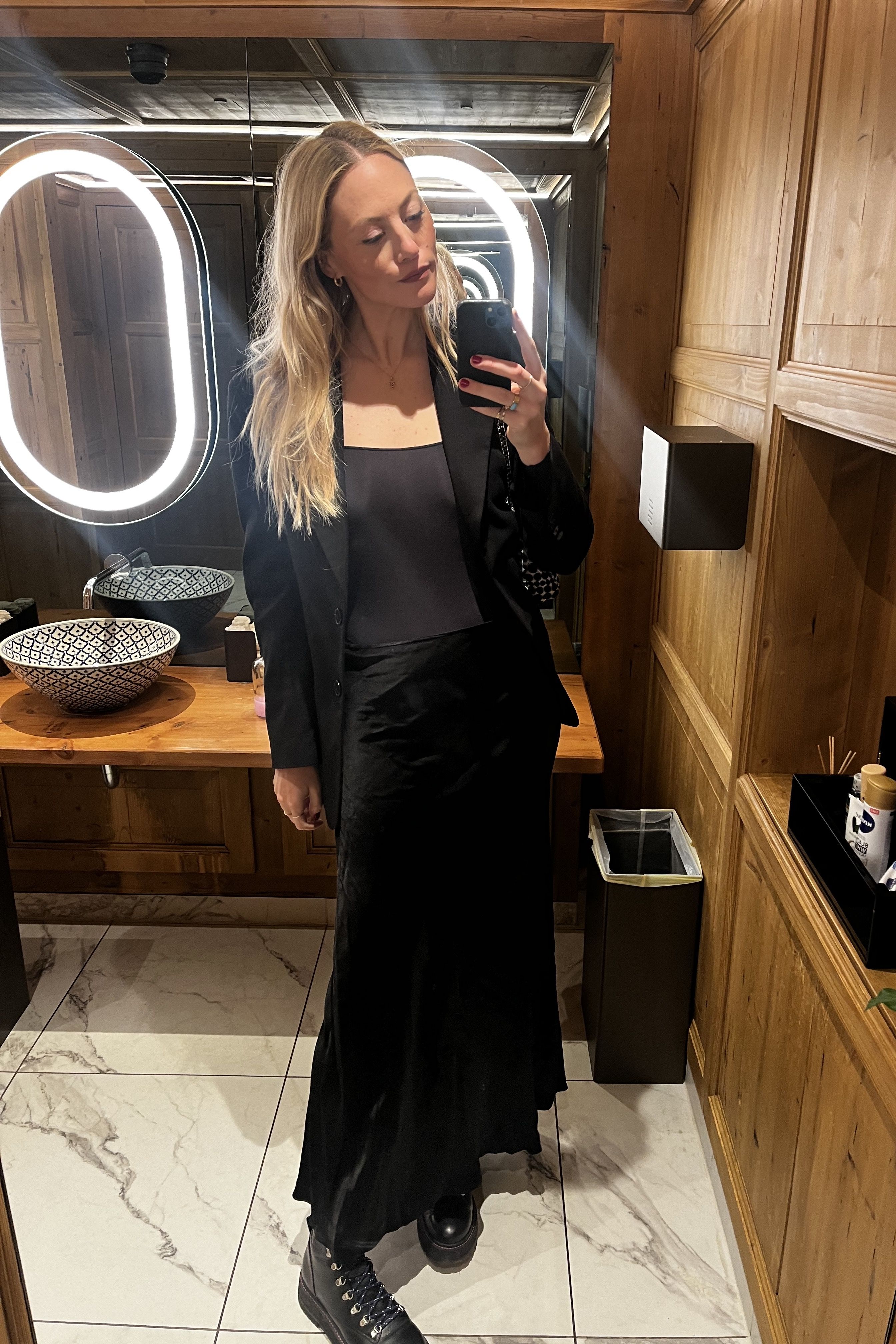 Brooke Ely Danielson taking a photo in the mirror in an all black outfit